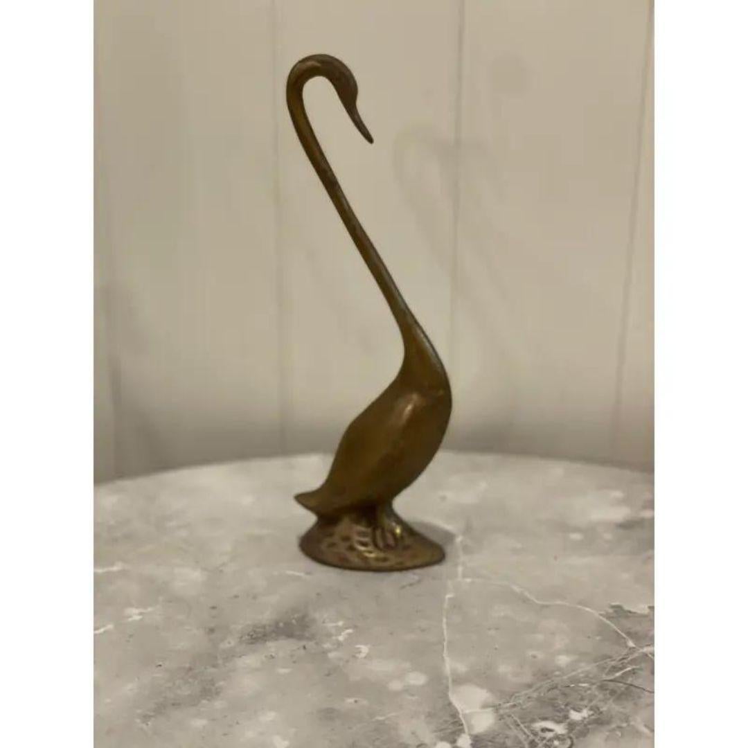 Vintage mid-century brass swan. 
Lightly polished to bring out the shine of the brass without taking away the patina. A unique brass figurine perfect for any bird lover. Coordinates well with chinoiserie-style decor.