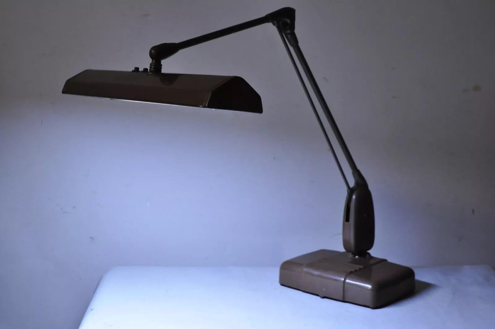 Vintage Mid Century Industrial Adjustable Brown Metal Desk Lamp by Dazor. Circa Late 20th Century. Measurements: 28