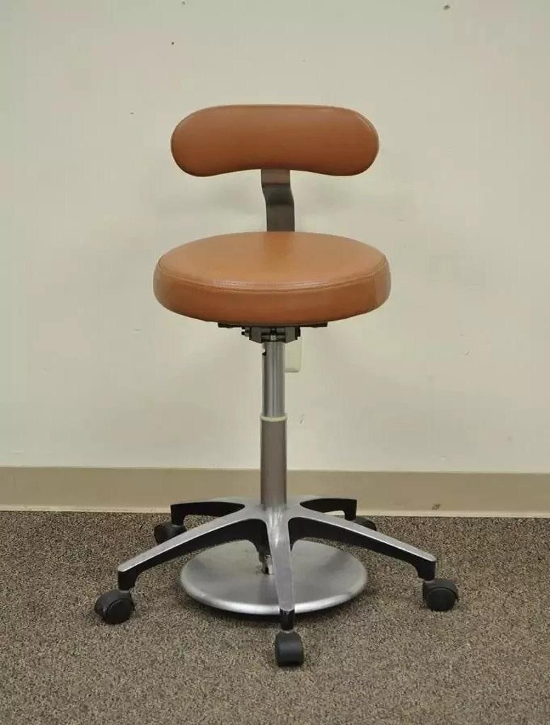 Vintage Mid Century Industrial Modern Adjustable Dental Dentist Chair Stool Seat. Item features cast aluminum frame, adjustable back, adjustable seat height. Seat adjusts by stepping on the round plate on the base. Very sleek design. Circa Late 20th