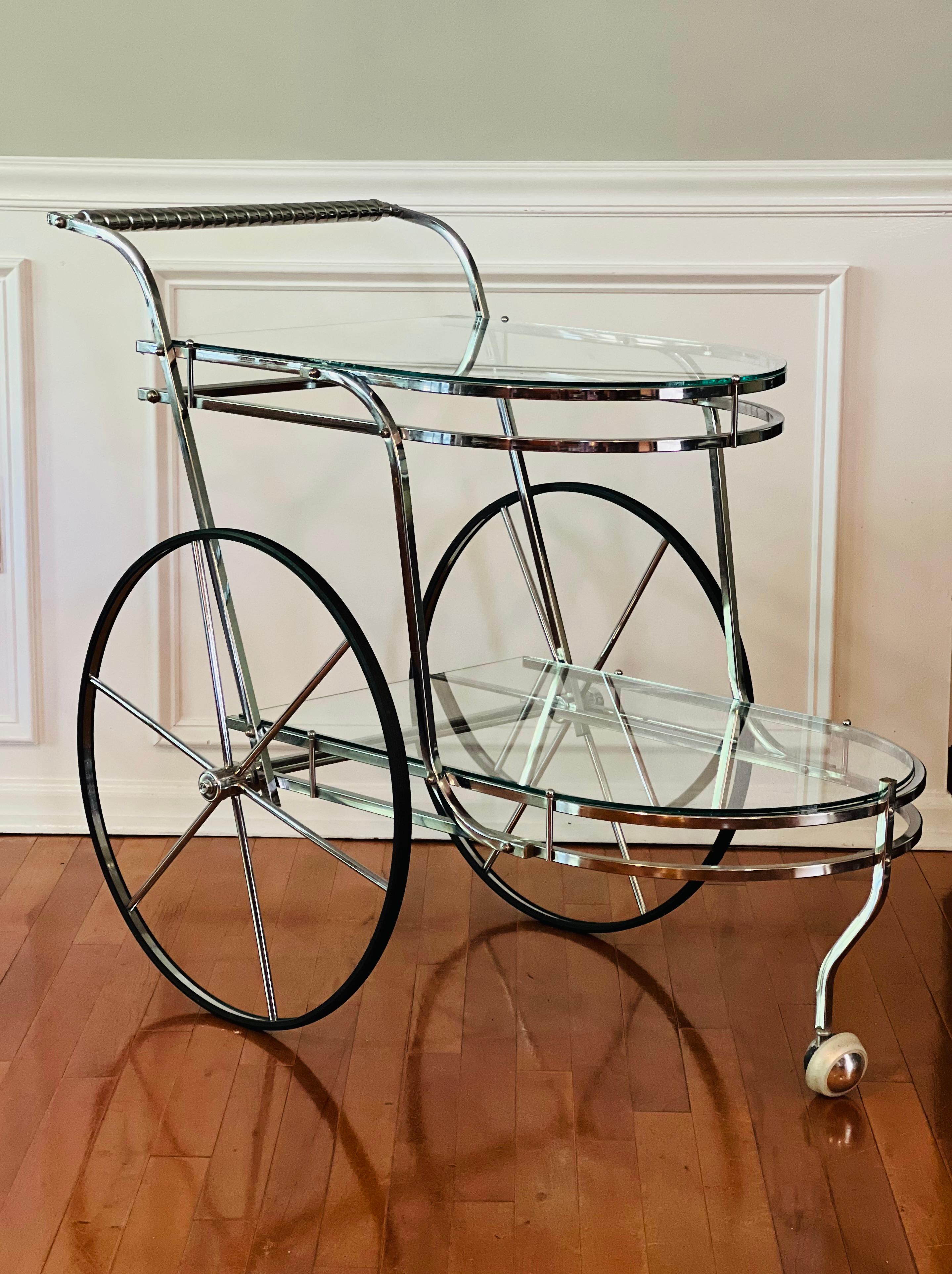 Elegant vintage polished chrome and glass two-tier Italian bar cart. 

Features two large carriage style wheels and one small front swivel one. Rope twist design handle. The chrome is brilliant and in very good condition. Beautiful.