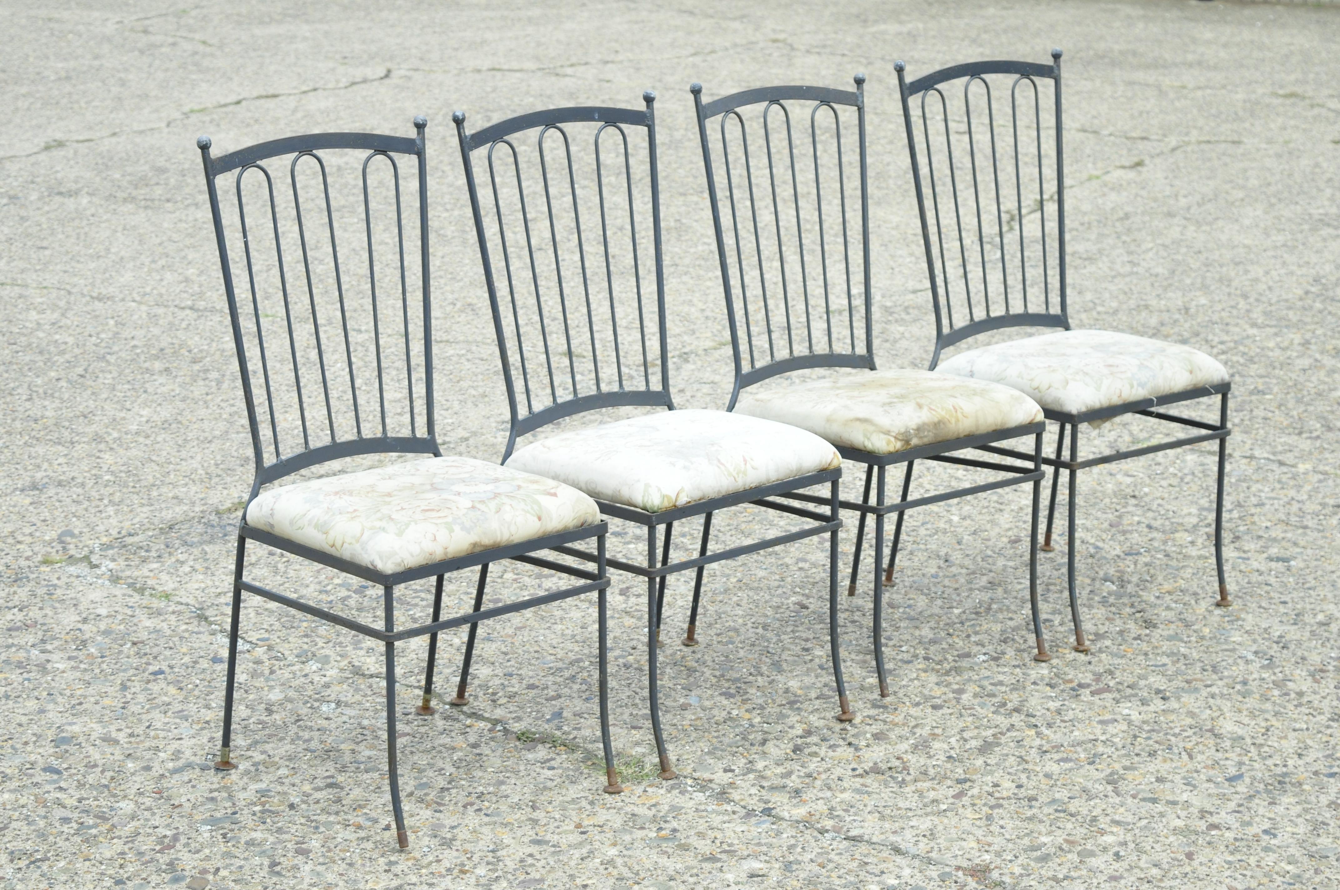 Vintage Mid Century Modern Italian Style wrought iron patio dining chairs - Set of 4. Set includes (4) side chairs, ball form finials, wrought iron construction, very nice vintage set, quality craftsmanship, sleek sculptural form. In the style and