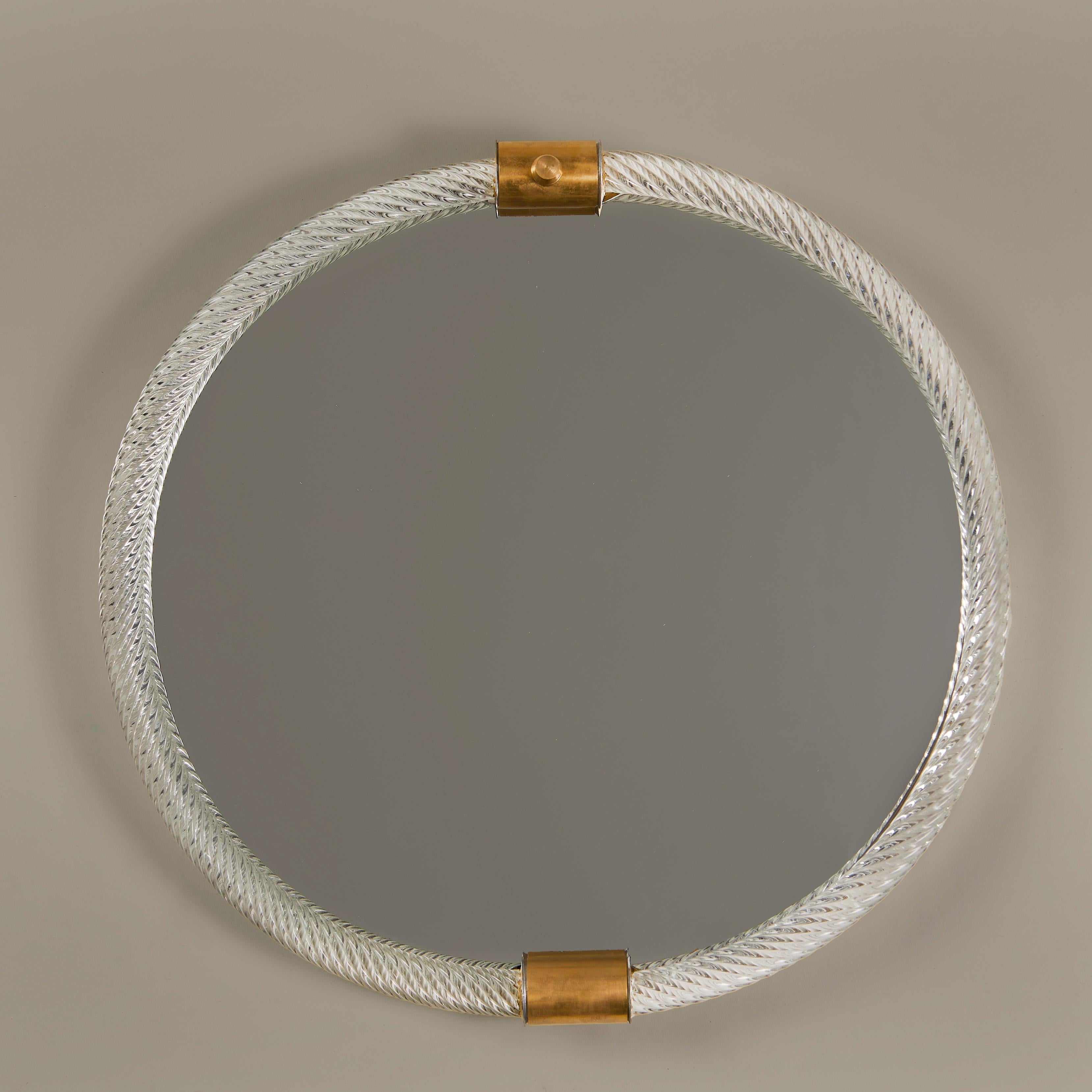 Elegant clear oval twisted glass wall mirror with two decorative brass clasps
