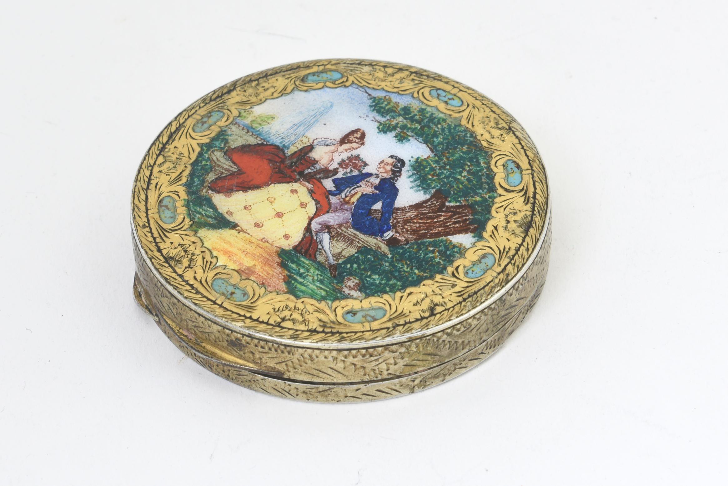 Italian 800 silver compact featuring a courting scene with a couple sitting on a bench under a tree with a tiny dog by his feet. Floral design hand chased 800 silver. Beveled mirror inside. Marked: 800.