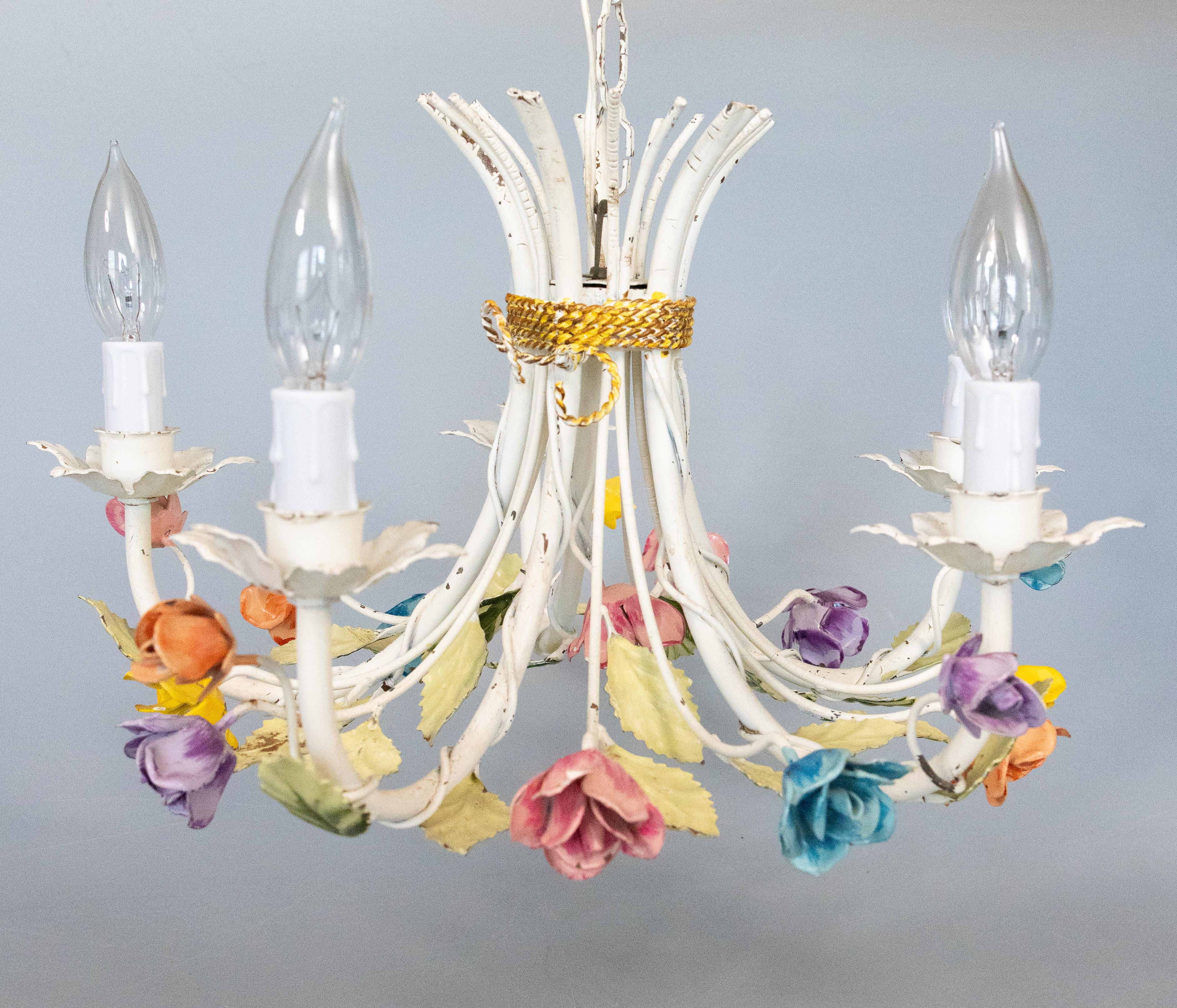 A gorgeous vintage Mid-20th century Italian tole five-arm floral chandelier. This charming hand painted chandelier has scrolling green leaves with lovely roses in many vibrant colors. It's in excellent working condition and retains the original
