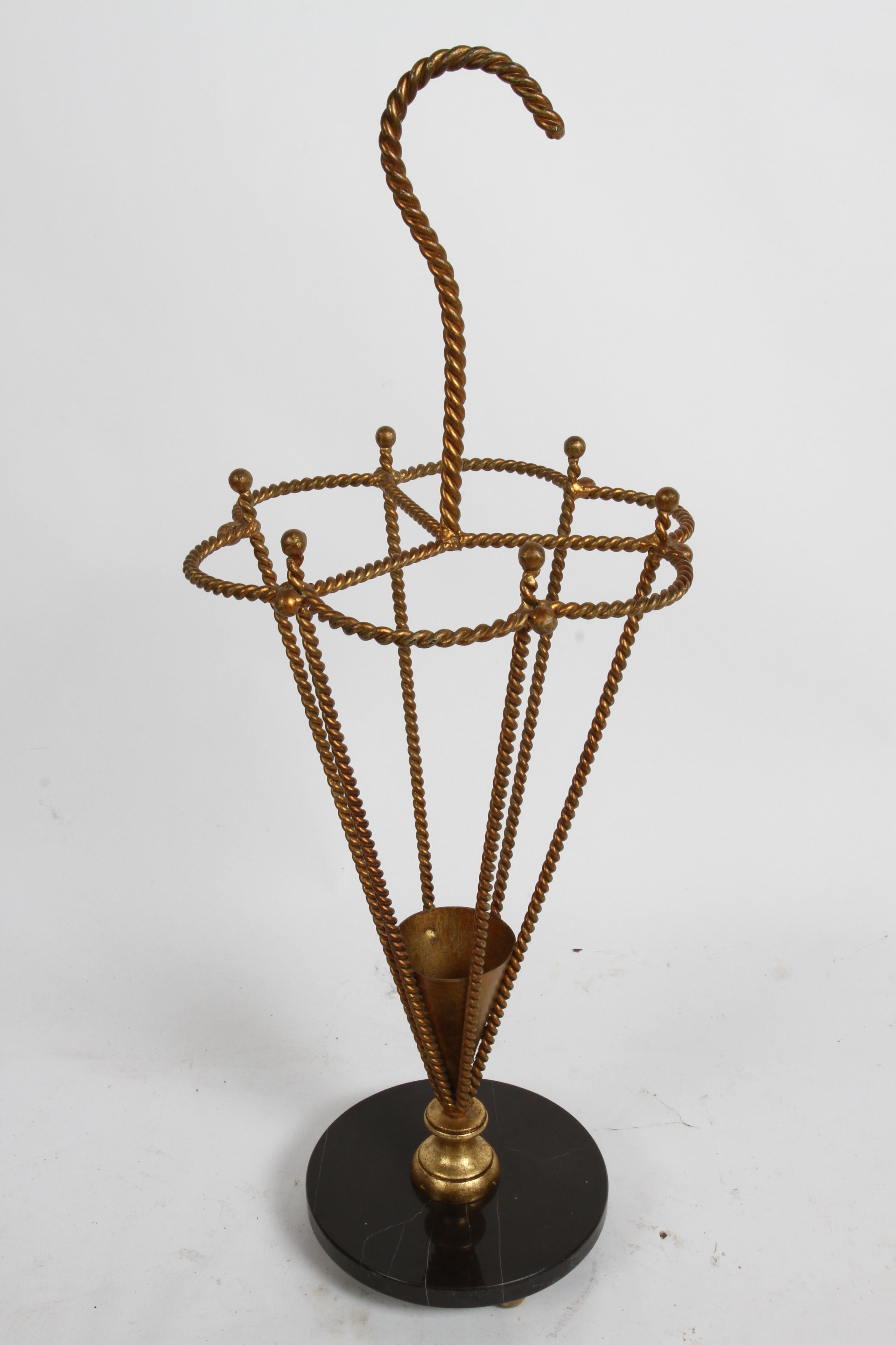 Vintage umbrella or cane stand, Italian made, takes form of an Umbrella, made of iron twisted rope with gold gilt and black marble base on brass ball feet. Light patina, light wear or loss to handle. Very well made.