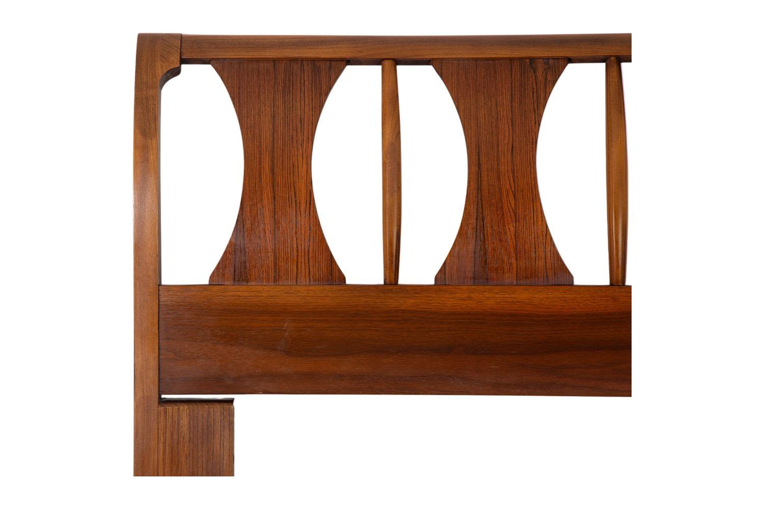 A remarkable mid-century walnut and rosewood Queen-size headboard by Kent Coffey in nearly pristine condition. Exceptional construction and style, features Kent Coffey's iconic design with five sculpted rosewood hourglass-shaped panels, accented
