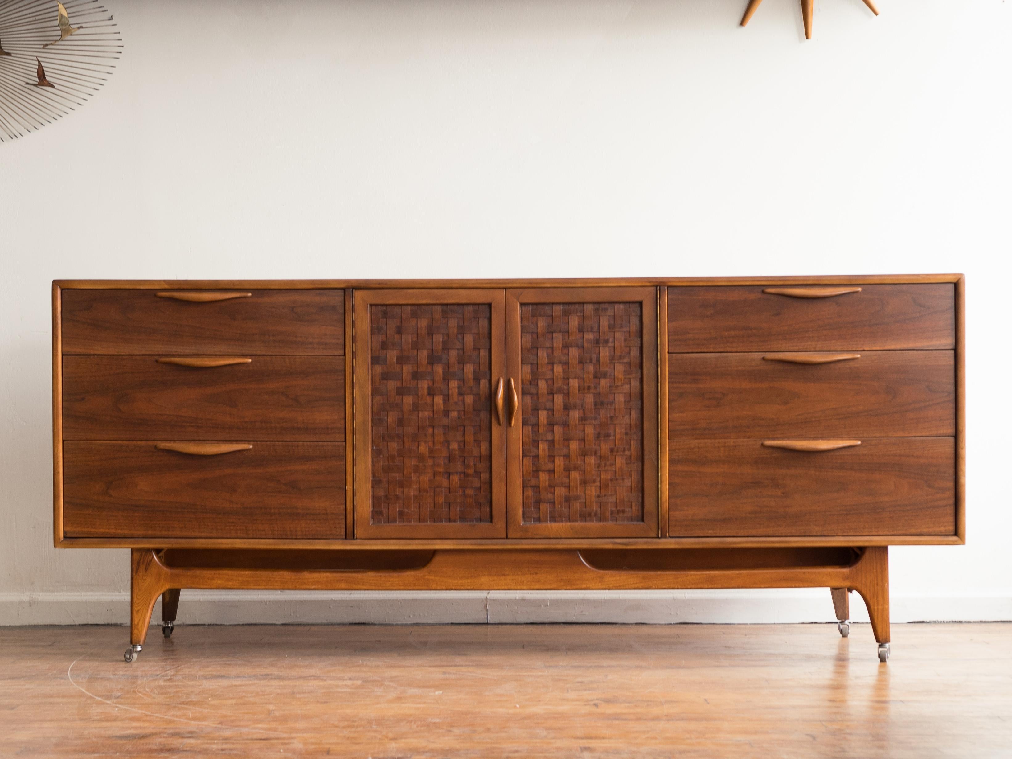 Gorgeous walnut dresser from Lane's Perception line. 

•six outer drawers
•a pair of basketweave doors hide three inner drawers
•rounded, sculptural handles
•mitered frame construction
•walnut body with contrasting elm trim