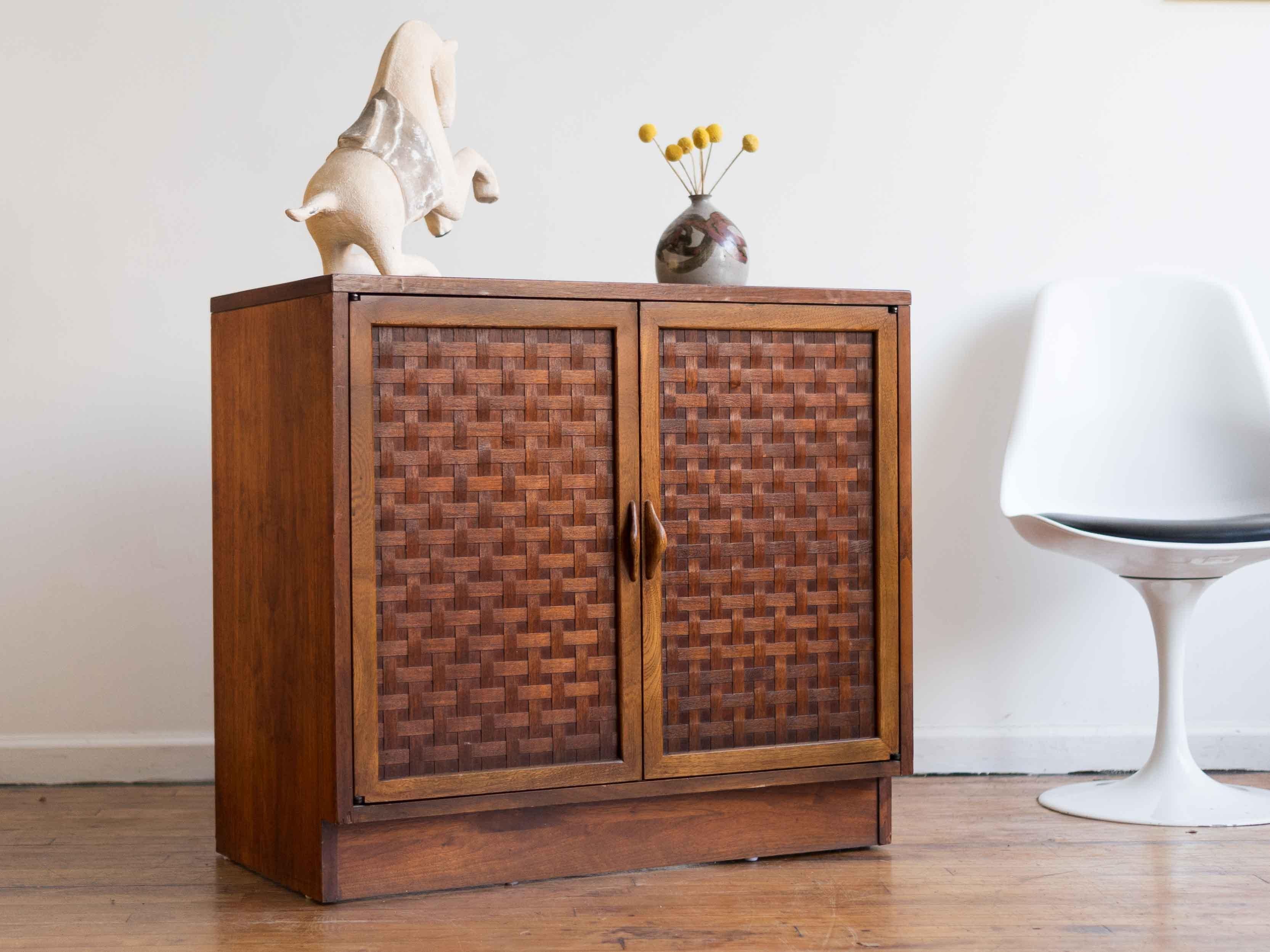32” x 17.5” x 29”H

Petite Lane Perception storage cabinet that works great as a buffet, entry table, or record storage. Features the line's signature basketweave doors and rounded wood pulls. One fixed shelf. Walnut wood throughout. 

Good vintage