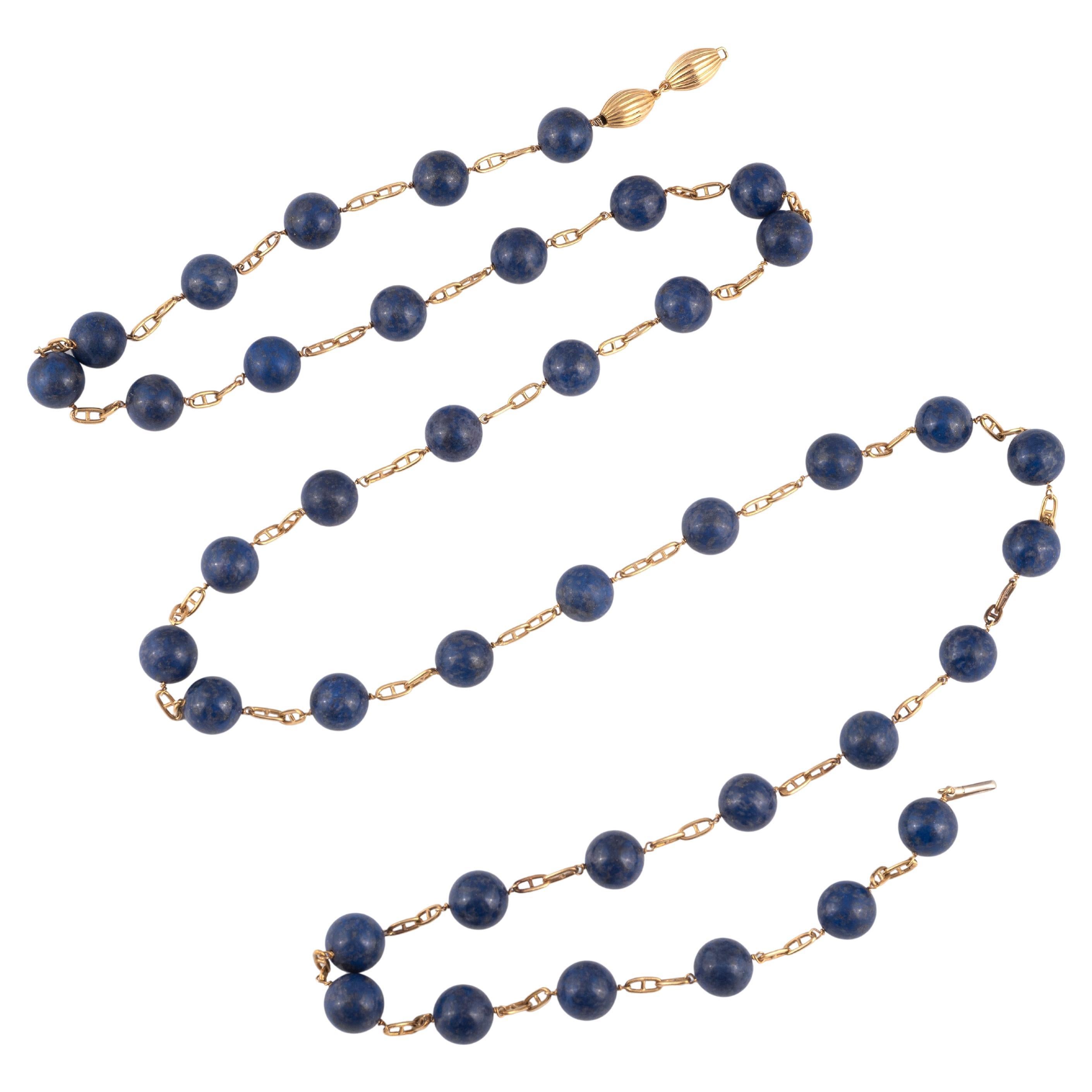 A detailed chain in 18 karat yellow gold provides the perfect backdrop to the main feature of the necklace – forty lapis lazuli beads 13mm. 
Lenght: 112cm
Weight: 131gr.

