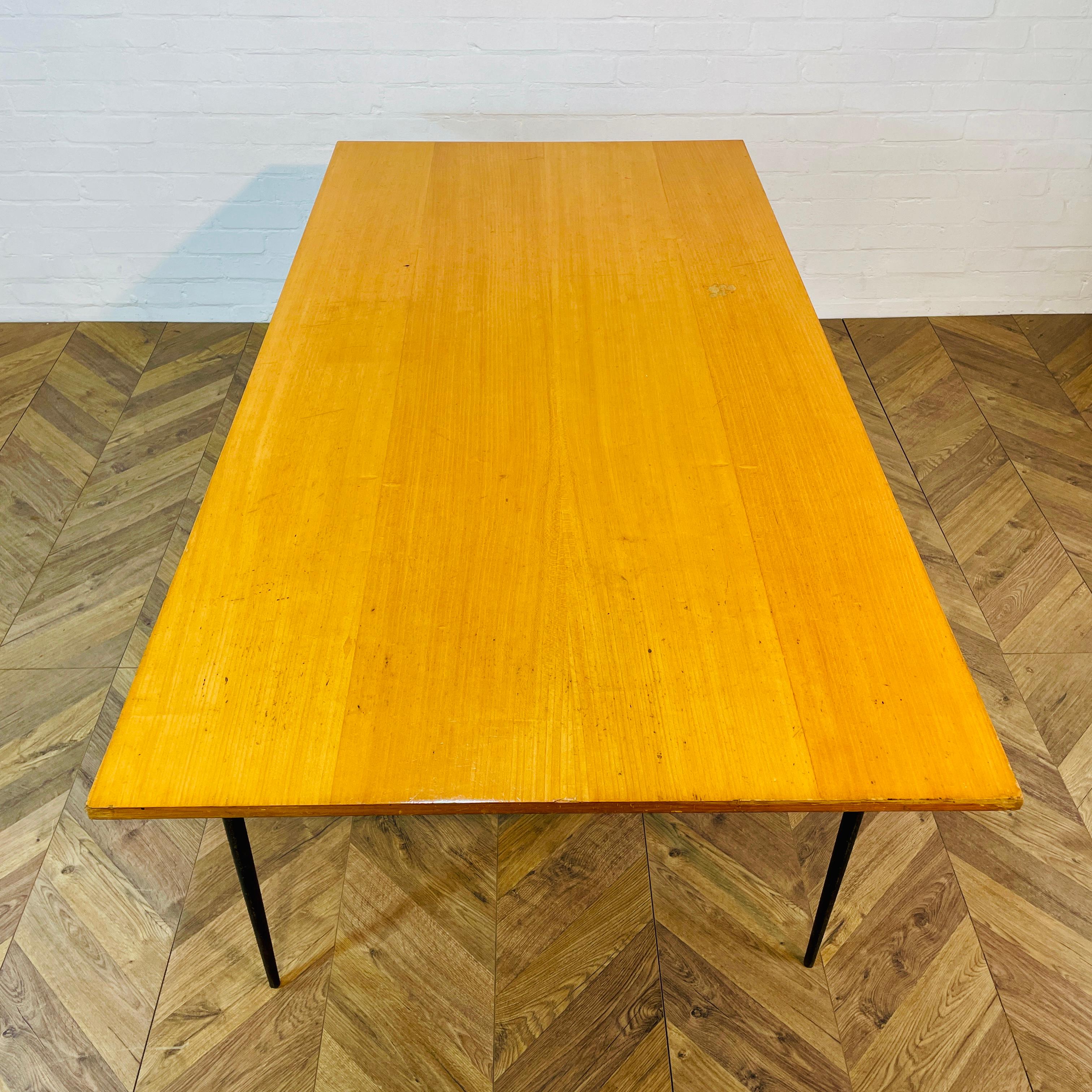 A Large Former Cambridge University Lab Table or Desk, circa 1970s / 80s.

The table sits on a black steel frame with a wooden top.

It has a lovely worn patina and is in great condition, but does have marks and wear to the frame and top, as