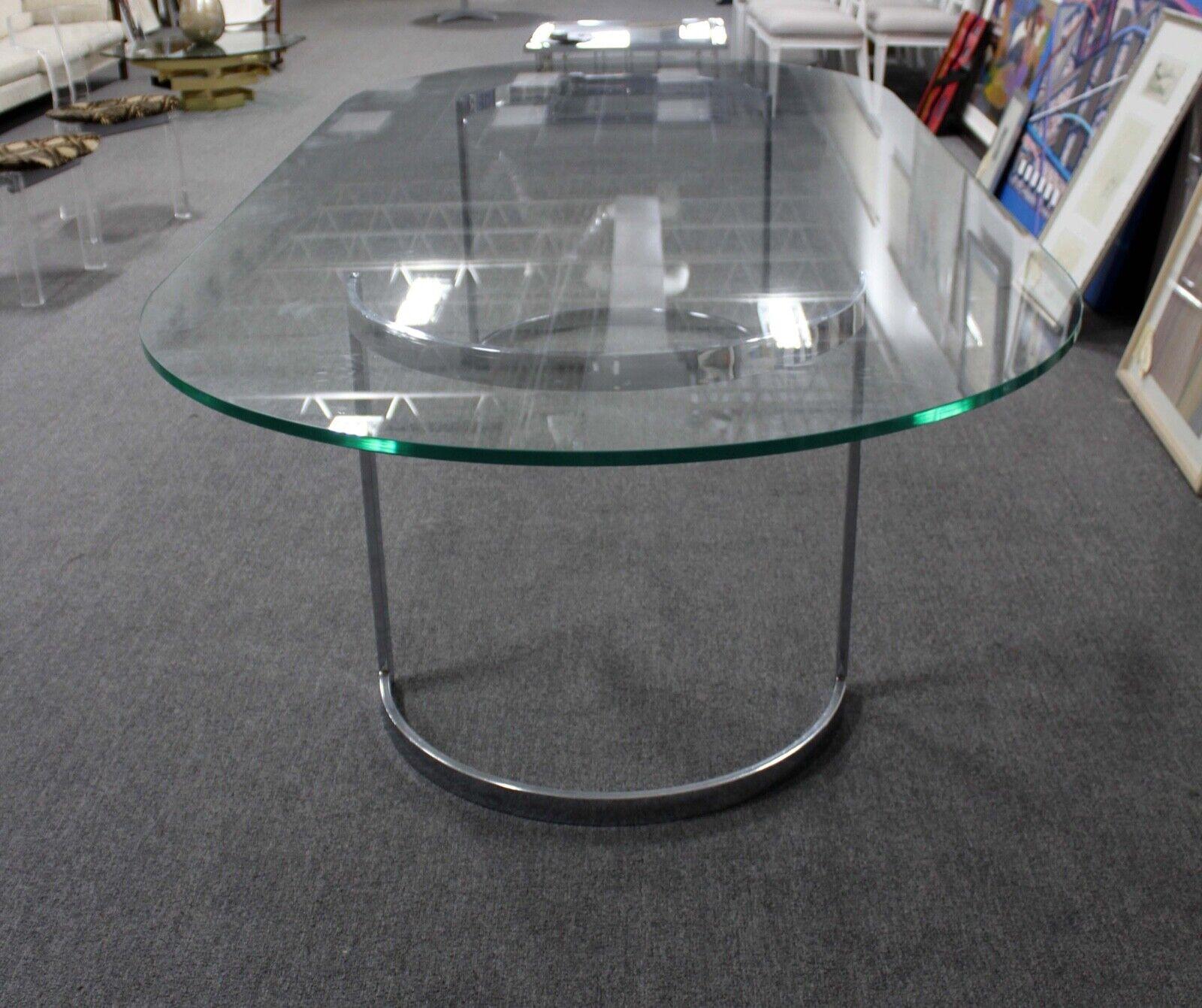 For your consideration is this monumental 10 foot glass dining table on curved chrome bases attributed to Milo Baughman. Dimensions: 119.5w x 55.5d x 30h.
 