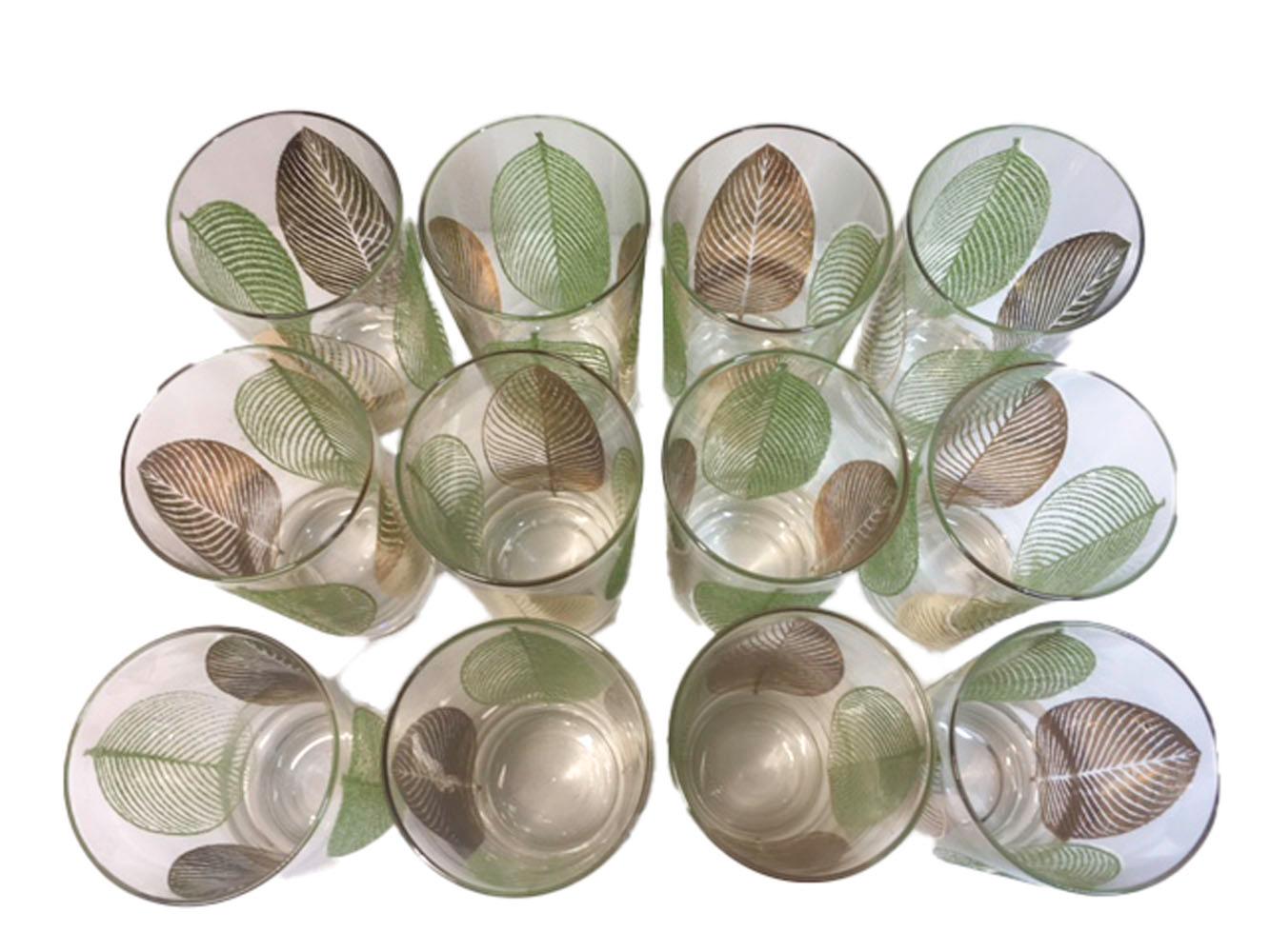 Rare set of 12 highball glasses, each with 4 leaves alternating 22k gold and green enamel. The leaves have a raised 