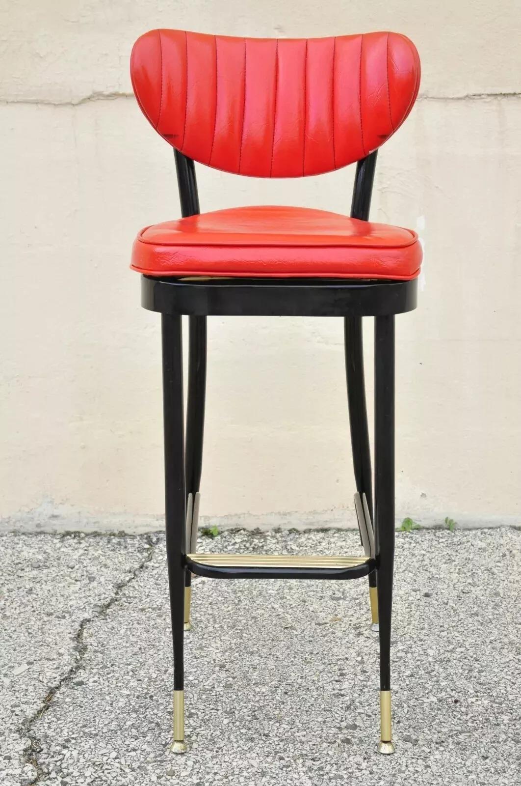Vintage Mid Century Black Metal Red Vinyl Italian Style Barstool by Lion Brand . Item features red vinyl upholstery, metal frame, original labels, tapered legs, clean modernist lines, quality American craftsmanship, great style and form. Circa Mid