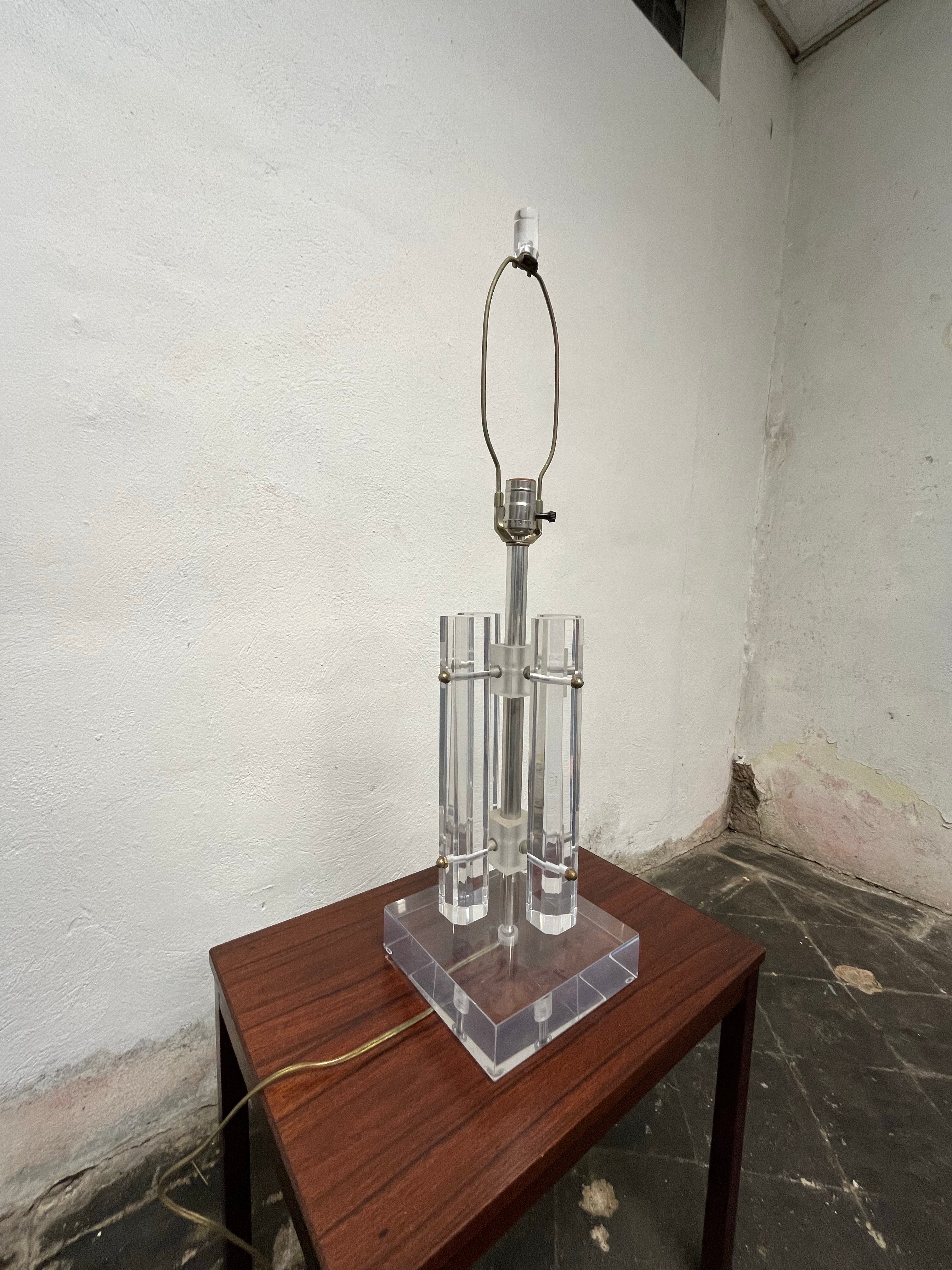Classic mid century lucite lamp. Four octagonal columns suspended off of center column topped with lucite cylindrical finial. Great clarity. 