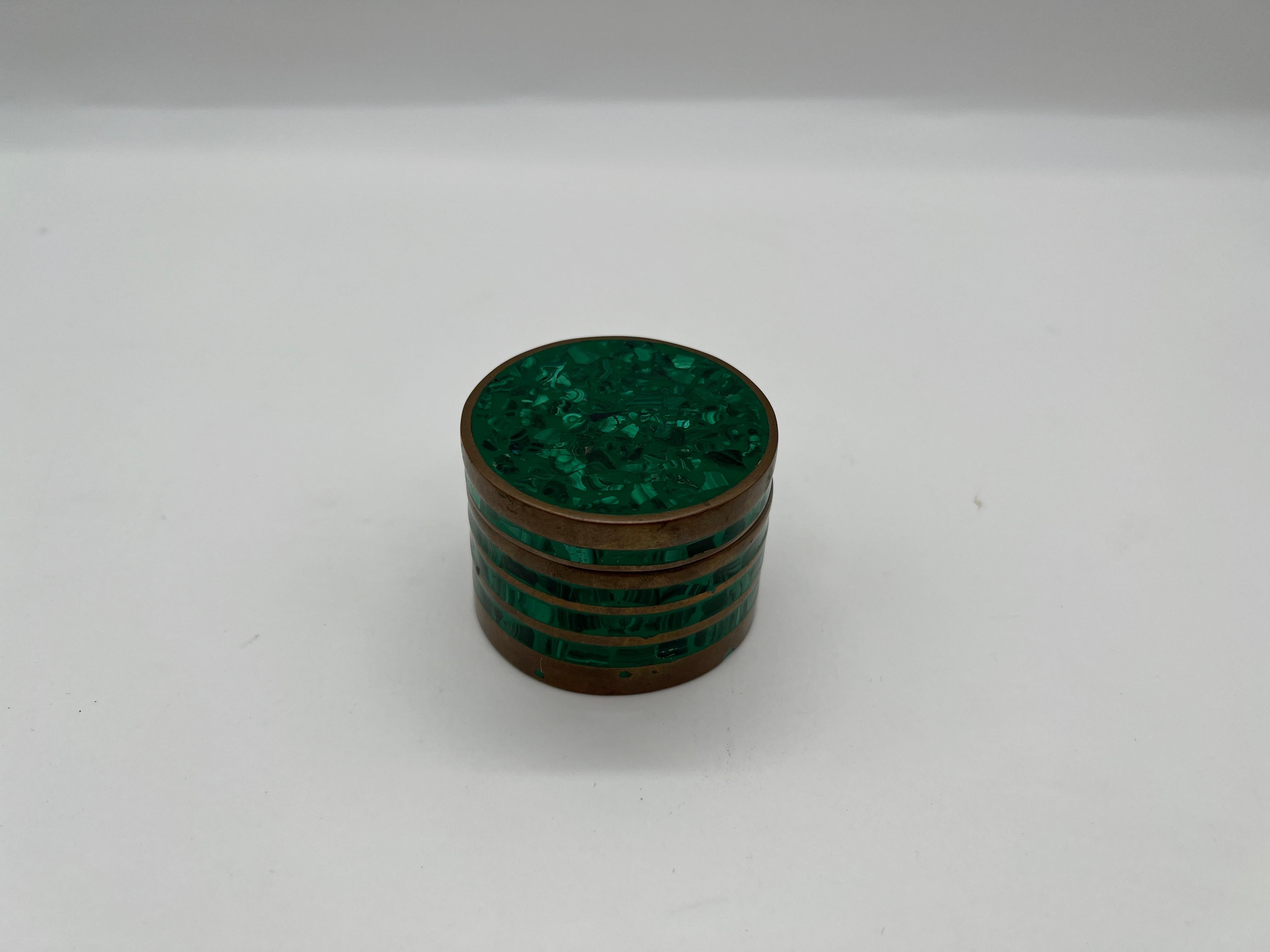A mid century malachite table box with tiered brass ring mounts. Original velvet interior. Unmarked.