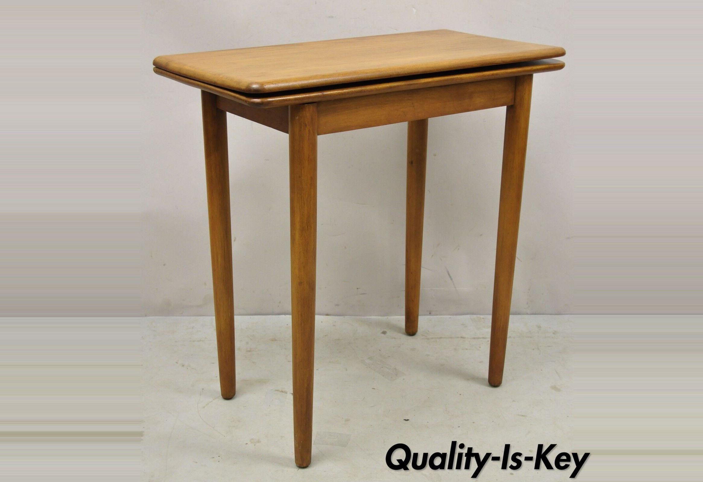 Vintage mid-century maple wood expanding folding game table. Item features removable tapered legs, flip and spin expanding top, beautiful wood grain, very nice vintage item, great style and form. Circa mid-20th century. Measurements: 30.5