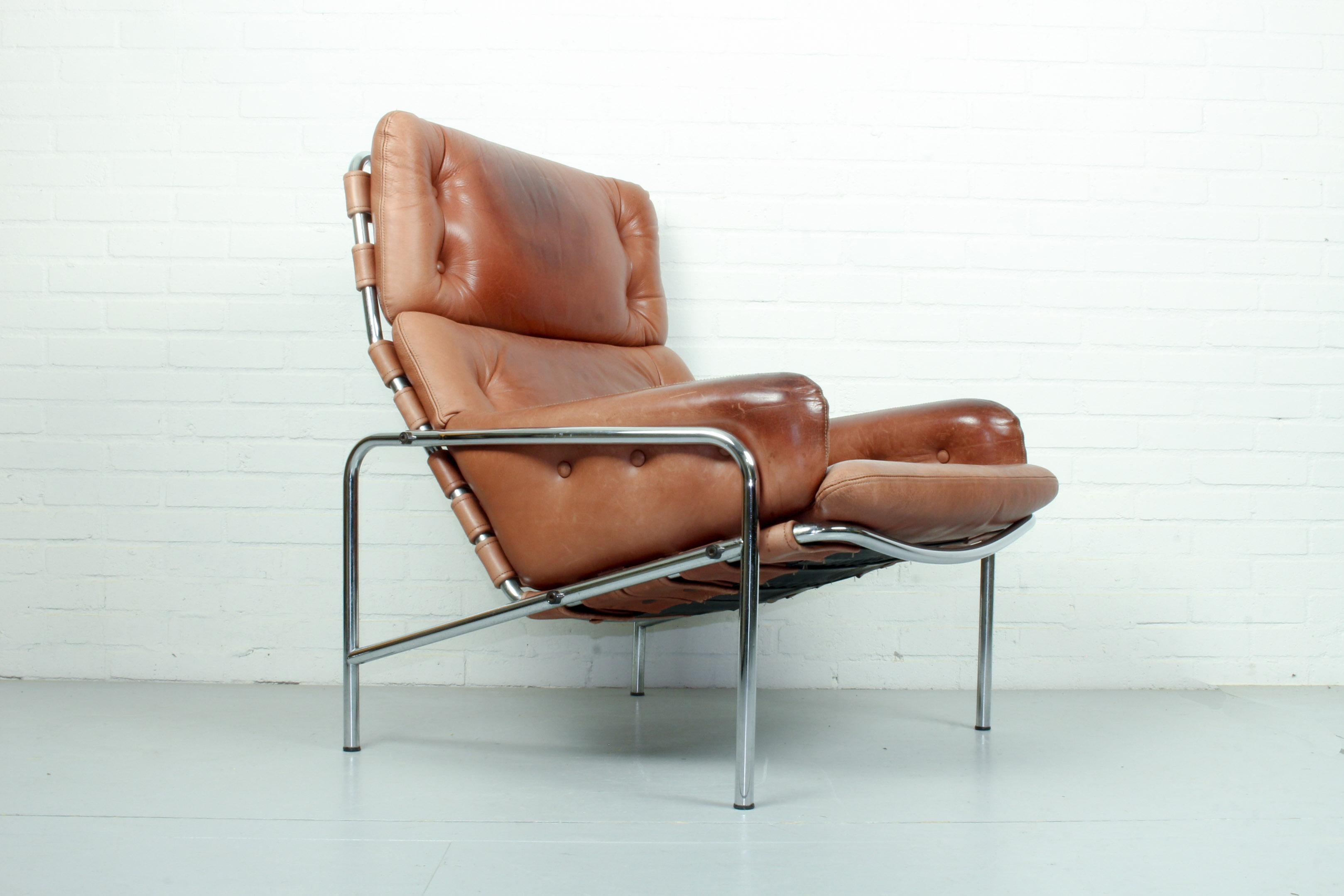 In 1969 this chair was designed by Martin Visser for the World Expo in Osaka Japan in 1970. Original brown leather in good condition with nice patina. The Bauhaus style frame is also in good condition.