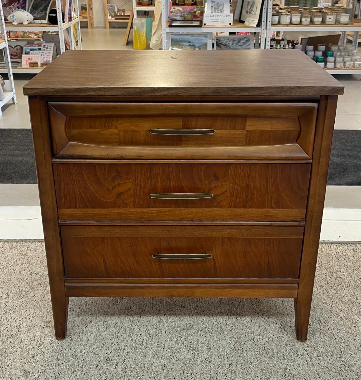 This walnut toned petite dresser has beautiful wood grain detailing on the drawers. Dovetail Drawers. Original hardware. Vintage Condition Consistent with Age as Pictured.

Dimensions. 30 W ; 18 D ; 31 H