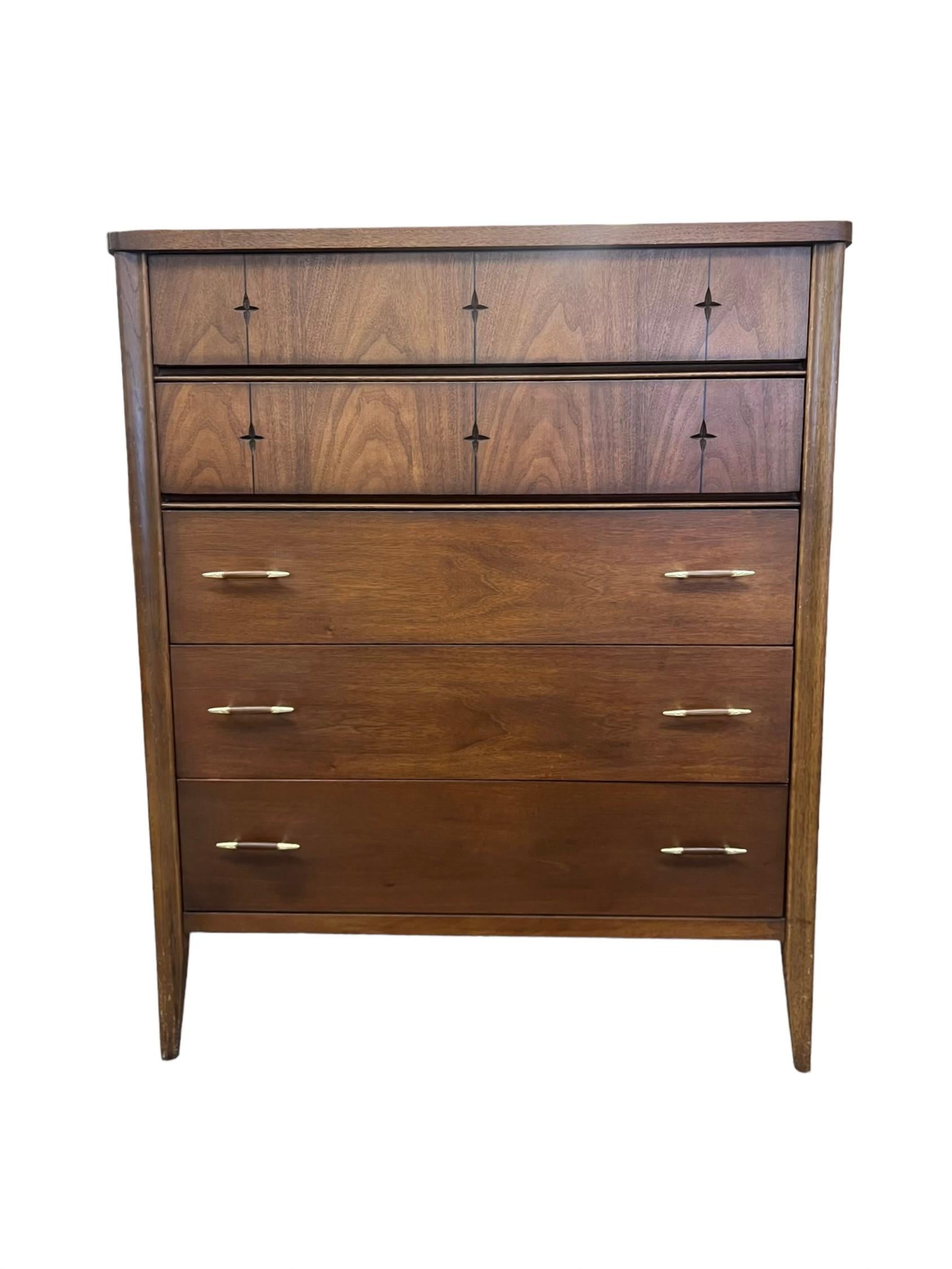  Mid century modern walnut highboy dresser with the signature �“star” inlays that the Broyhill Saga line is known for. In good vintage one owner condition with original finish. 
Dimensions. 
38.75W 19.25D 46.5H