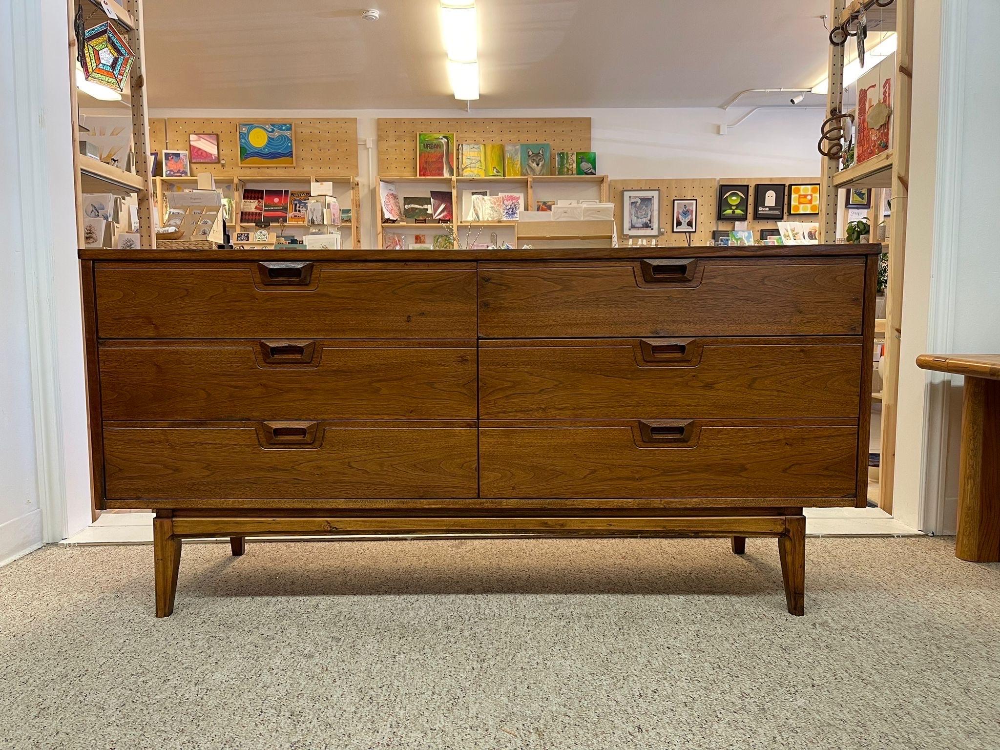 This Piece has 6 Dovetailed Drawers, walnut tone and wood carved handles. Vintage condition consistent with age as Pictured.

Dimensions. 62 W ; 18 D ; 30 H