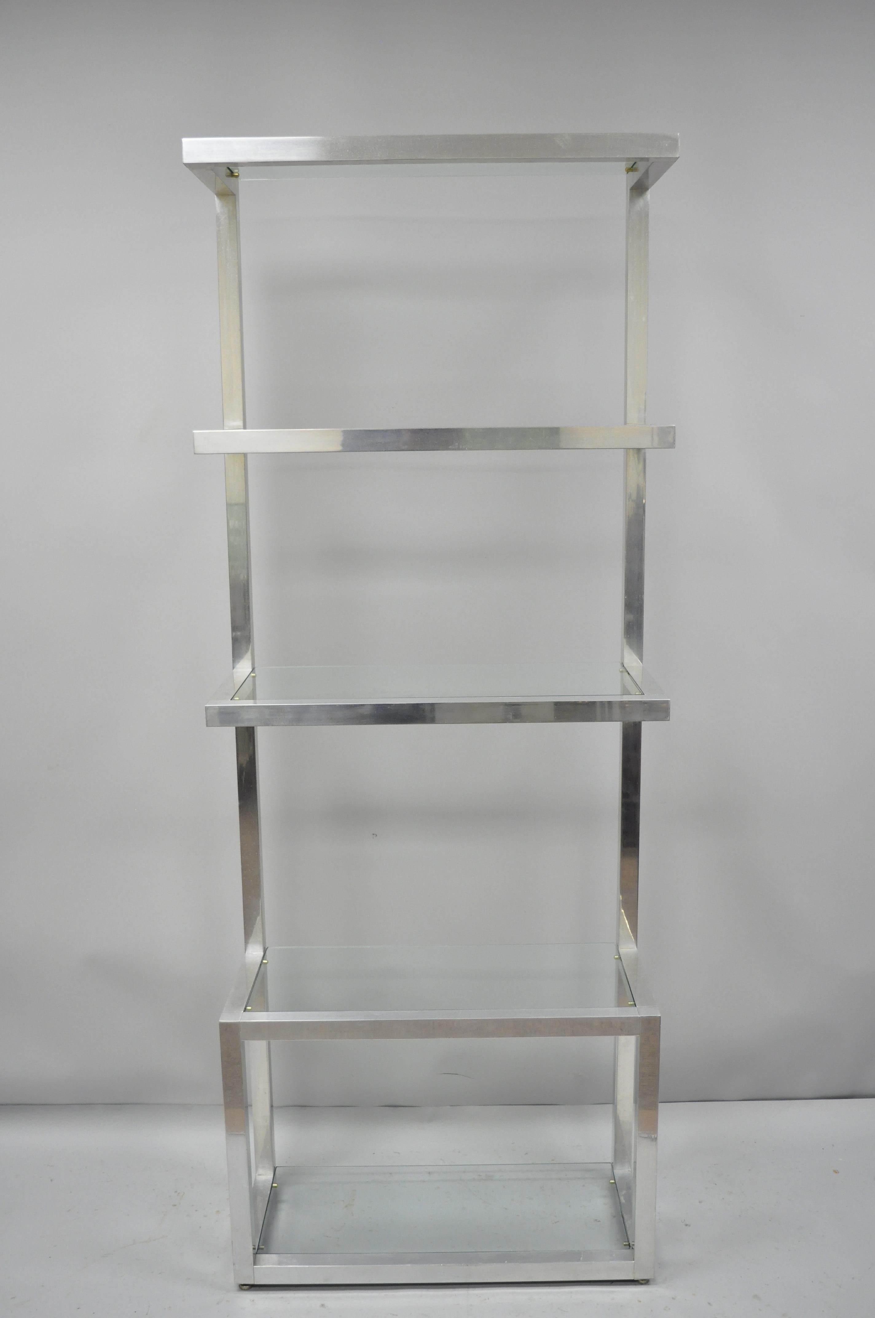 Vintage Mid-Century Modern aluminum and glass etagere floating display shelf. Item features square aluminum tube construction, floating shelves, clean modernist lines, 5 glass shelves, great style and form, circa 1970. Measurements: 80.5