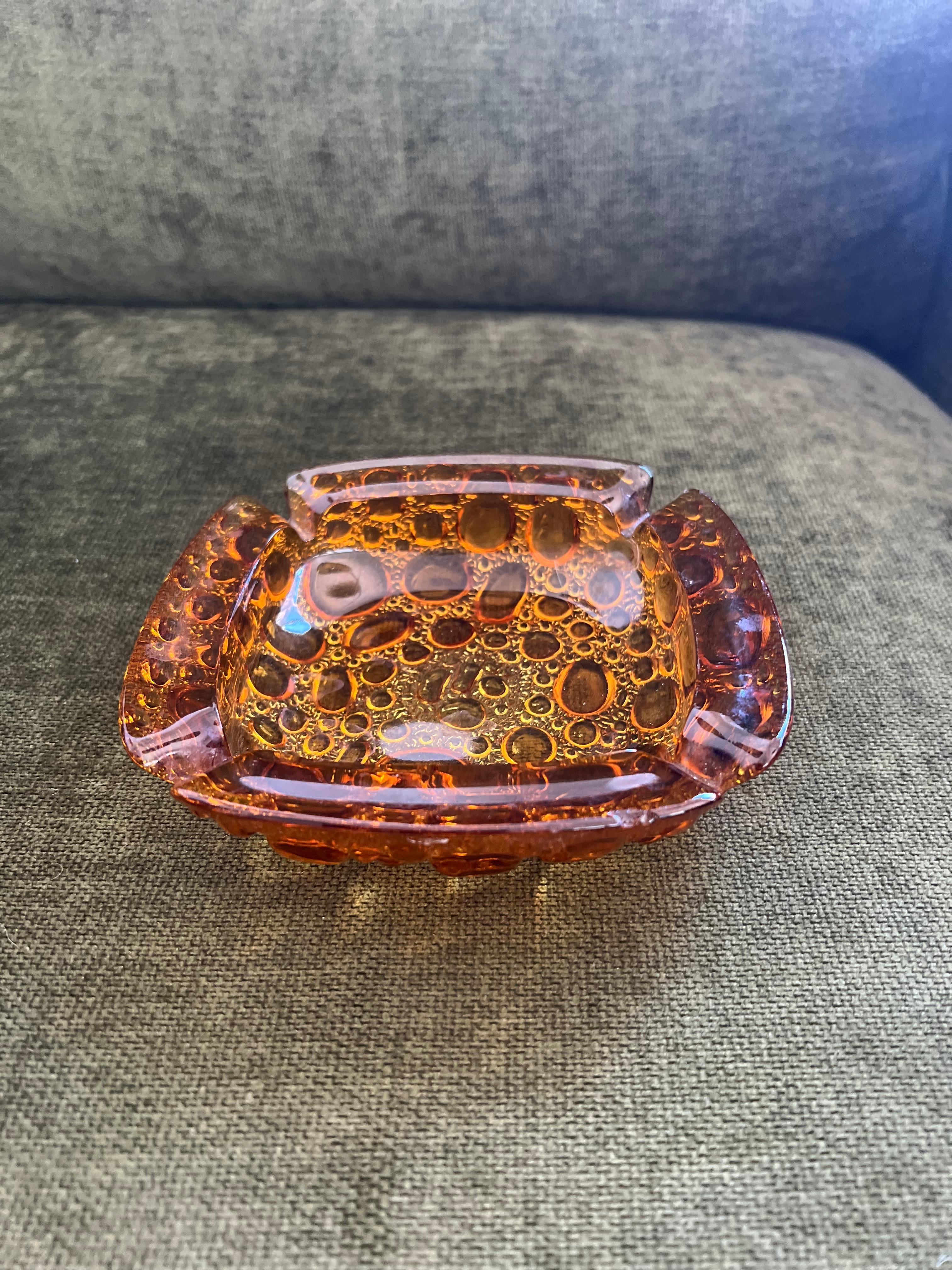 Vintage Mid Century Modern Amber Yellow LIBBEY Ashtray Bubble Pebble Glass
Circa 1970
This vintage ashtray is a gorgeous example of mid-century modern design. The amber yellow Libbey glass features a unique bubble pebble texture that adds visual