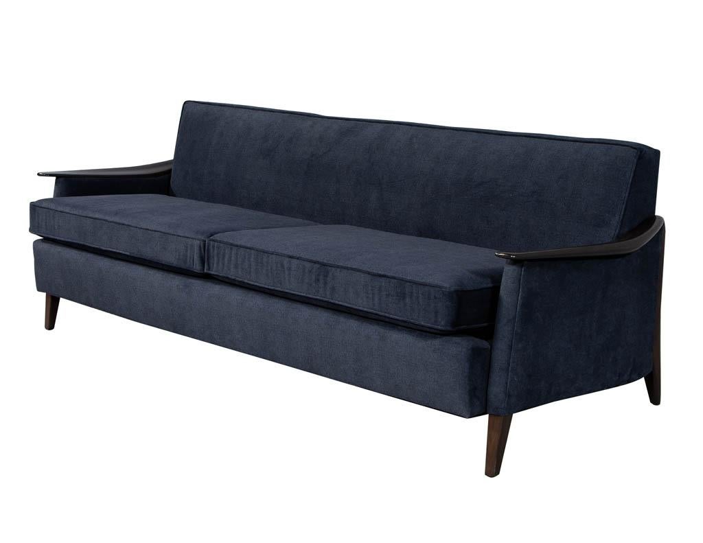 Vintage American made circa 1960s Sofa. Featuring walnut wood trim and new upholstery in Maxwell – Baxter ESS #800 Navy fabric. A true iconic 1960s Mid-Century Modern design from the USA.