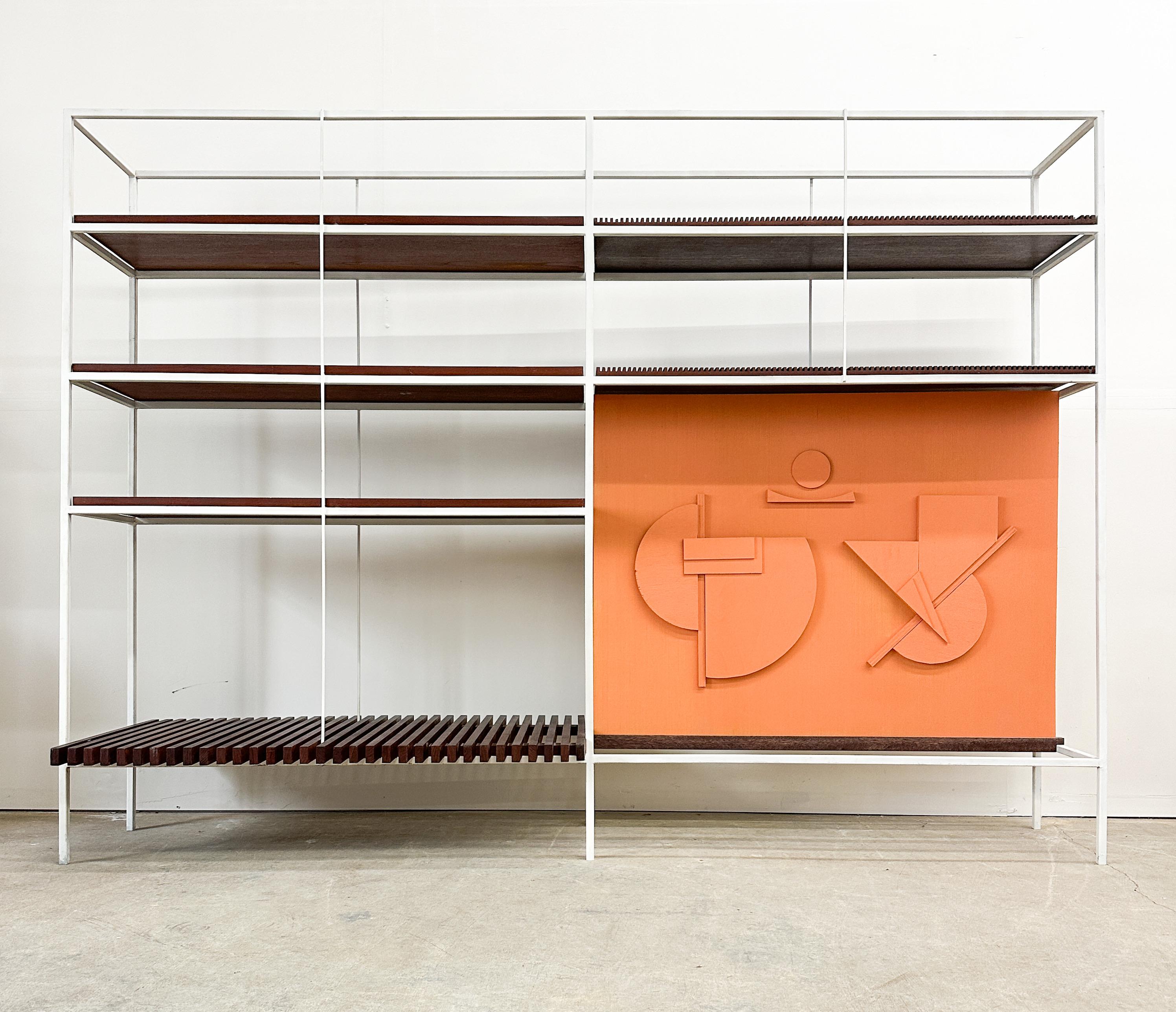 From well known mid century modern architect's Pittsburgh studio, this minimalist shelving unit features a combination of solid walnut shelves, grooved walnut shelves and walnut slats. There is an open section lower right suitable for art or larger