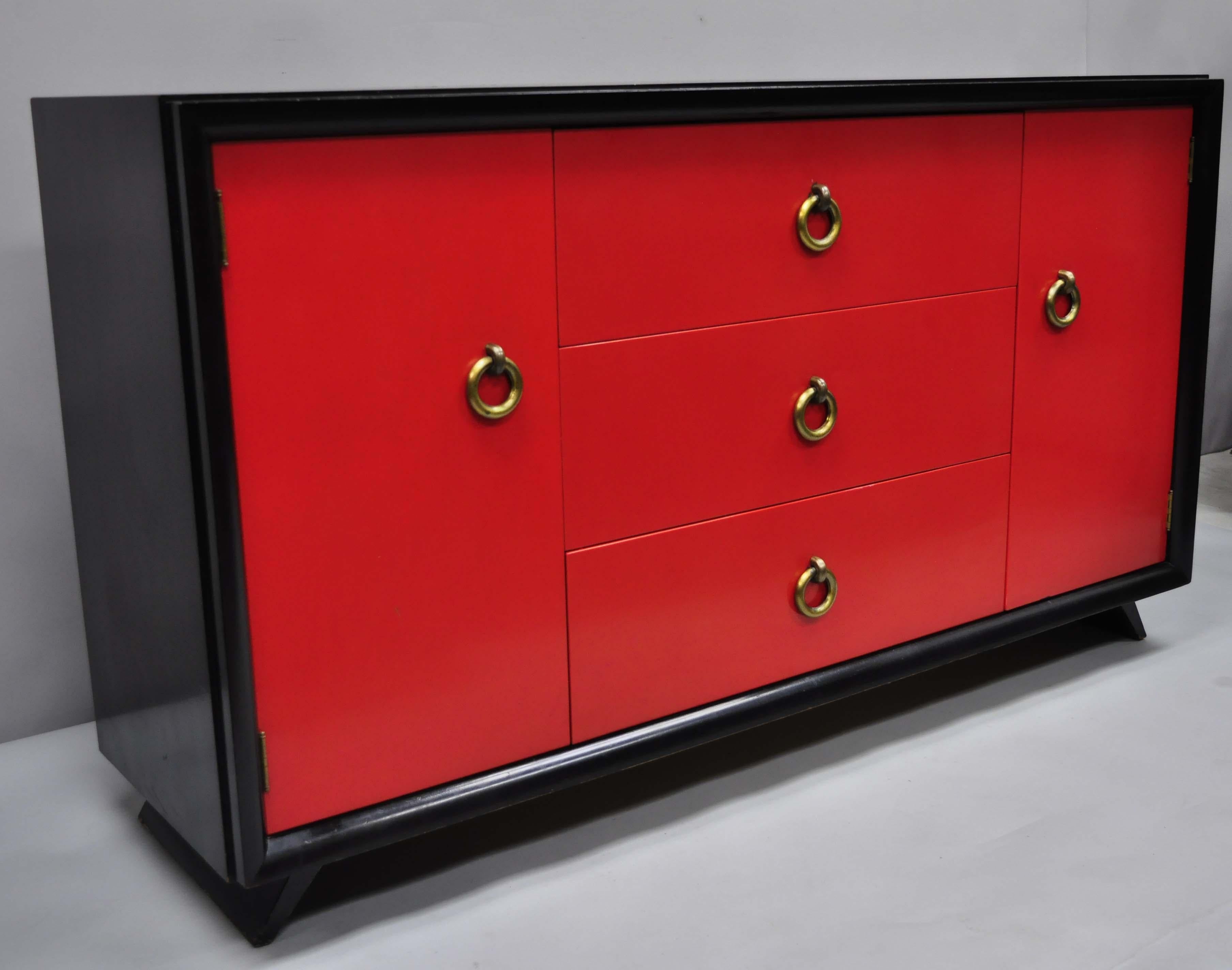 Vintage Mid-Century Modern Art Deco black and red credenza cabinet sideboard by Harjer furniture ltd. Item features heavy drop brass ring pulls, black and red lacquer finish, 2 swing doors, original label, 3 drawers, clean modernist lines, quality