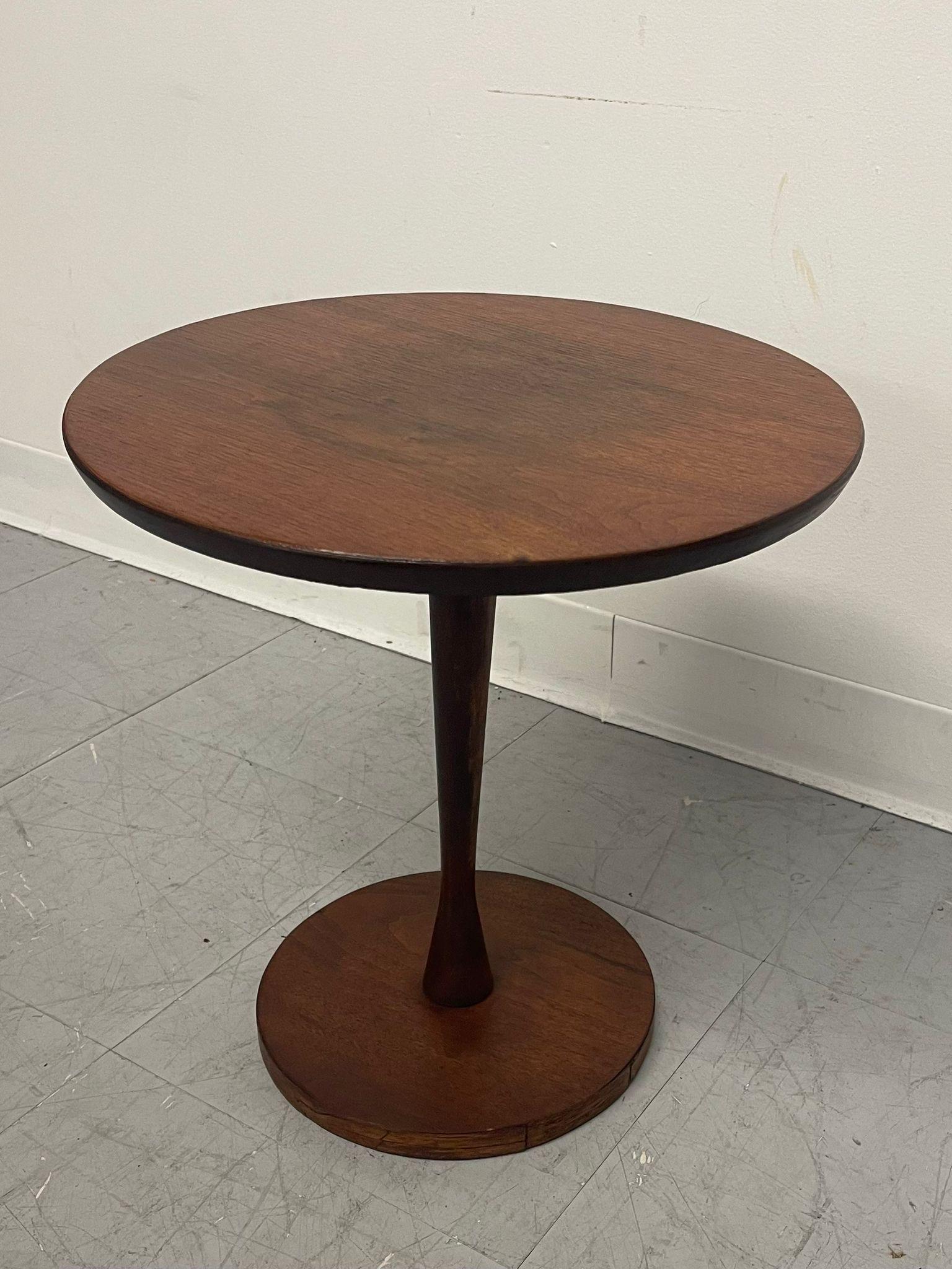 Circular Side Table with Atomic Curvature to the Column Trunk. Circular Base. Vintage Condition Consistent with Age as Pictured.

Dimensions. 15 1/2 Diameter ; 16 H