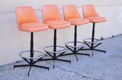 Vintage Mid Century Modern Atomic Orange Vinyl Metal Swivel Barstools - Set of 4