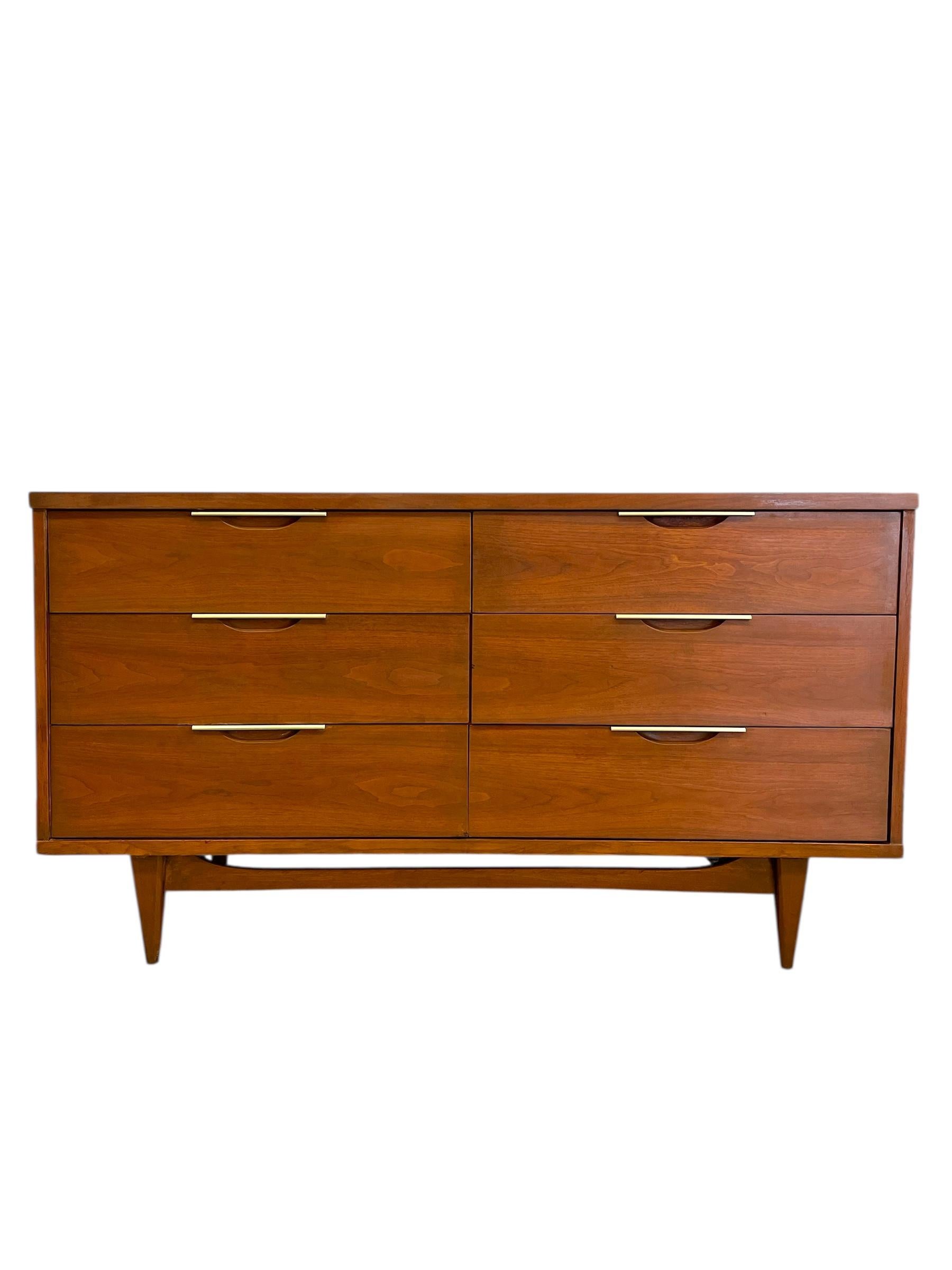 This vintage mid-century modern dresser set is from the sought-after Tableau Collection by Kent Coffey, dating from the 1960s. The set includes a six-drawer lowboy dresser and a five-drawer highboy chest, each showcasing the clean lines, functional