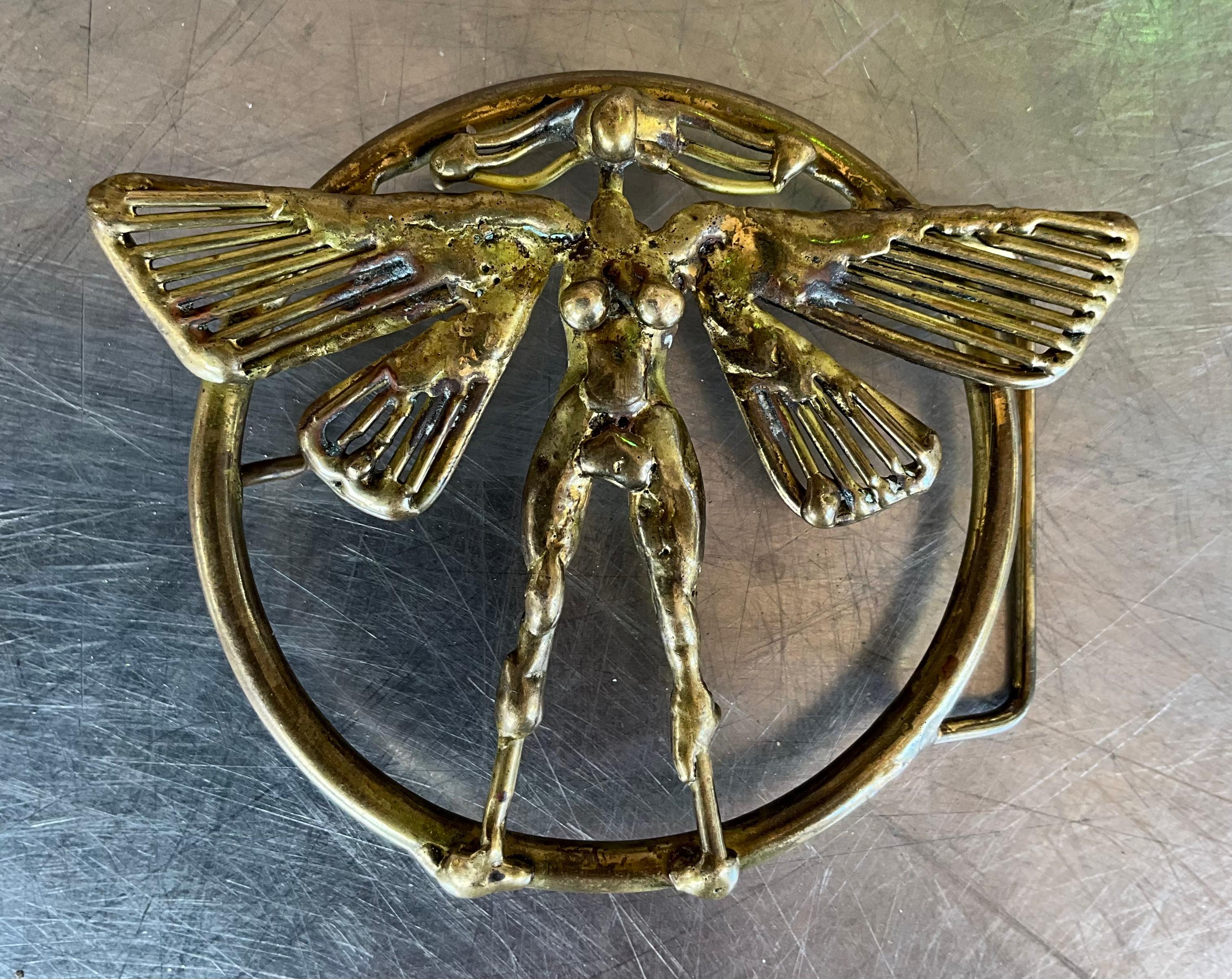 This Vintage Mid Century Modern Belt Buckle is an artful blend of form and function. Crafted in the distinctive mid-century modern style, it features sleek, minimalist design elements that were hallmark traits of the era. Expect to see clean