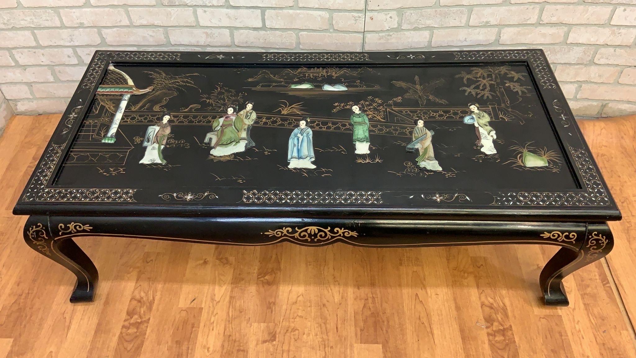 Vintage Mid Century Modern Black Lacquer Chinoiserie Coffee Table with Mother Of Pearl Inlays 

A mid century modern chinoiserie, black lacquer and partly exposed wood coffee table with inlaid mother of pearl on curved legs. The surface depicts