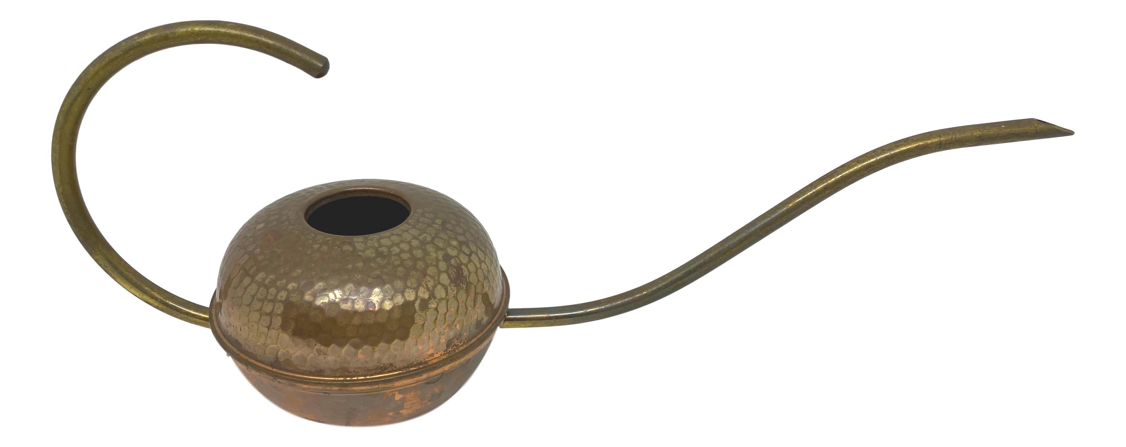 A gorgeous vintage Mid-Century Modern brass and copper watering can with a long spout. Great lines, great original condition with wonderful patina.