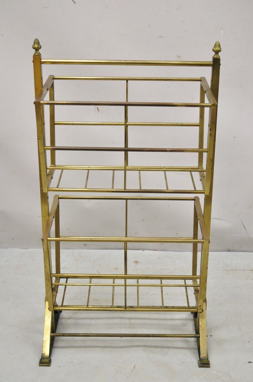 Vintage Mid-Century Modern brass frame 2 tier magazine rack stand. Item features a (2) tier design, brass frame, very nice vintage item, clean modernist lines, great style and form. Circa mid-20th century. Measurements: 34.5