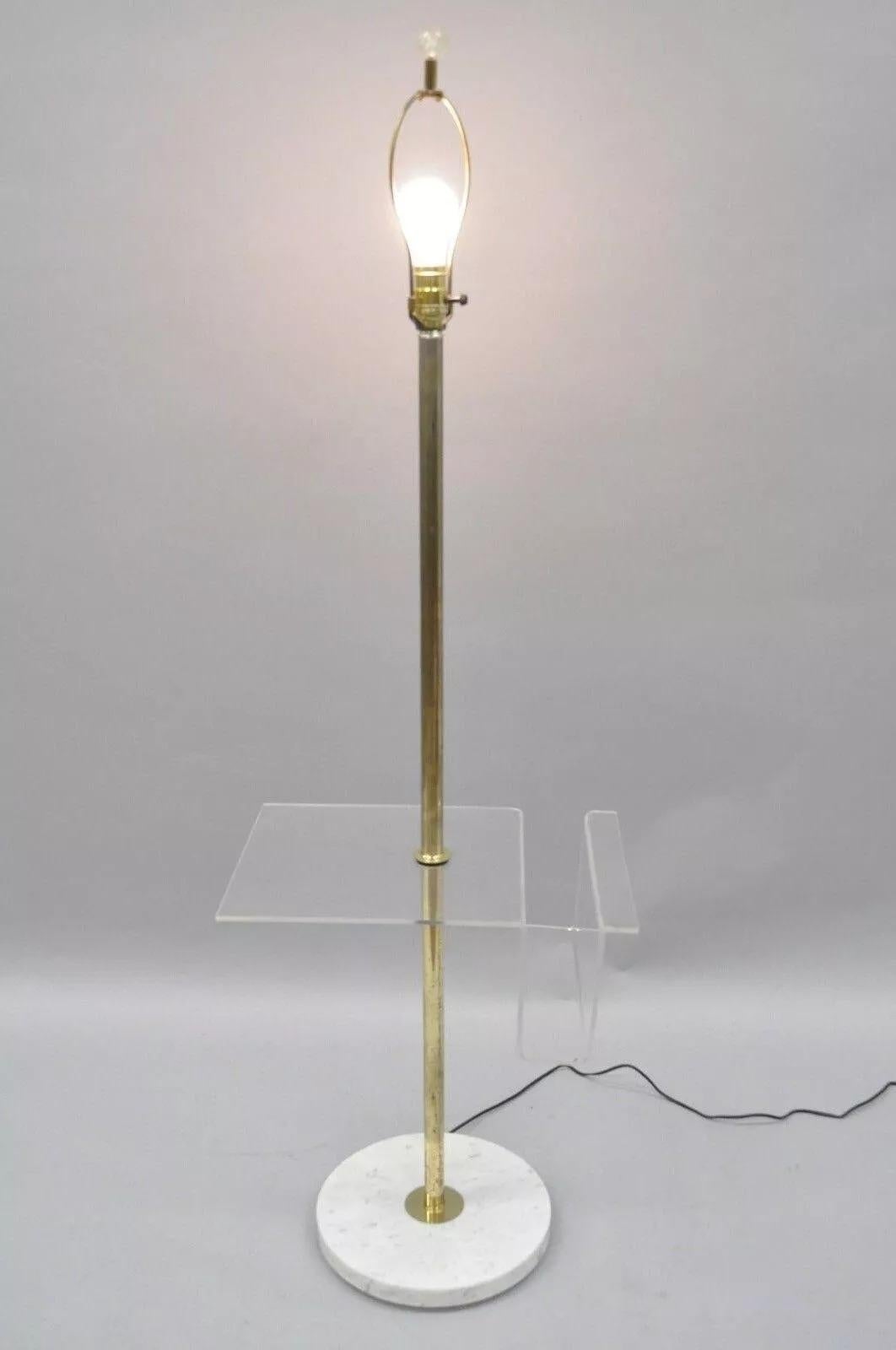 Vintage Mid Century Modern Brass Lucite Marble Floor Lamp with Magazine Table Rack. Item features a lucite magazine/letter holder, brass rods, marble base, very nice vintage item. Circa 1960's. Measurements: 56