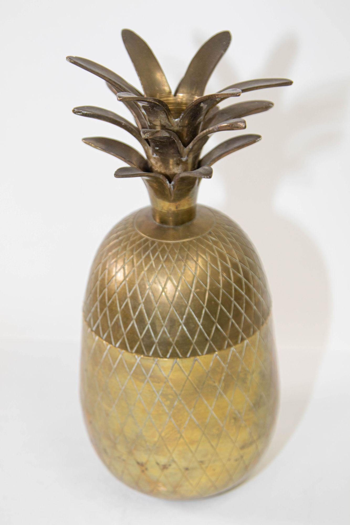Vintage decorative lidded ice bucket in the shape of pineapple will brighten your table.
Gold tone solid brass pineapple shape jar with lid.
Midcentury brass ice bucket with an ovoid shape with an engraved trellis pattern.
Fine craftsmanship solid