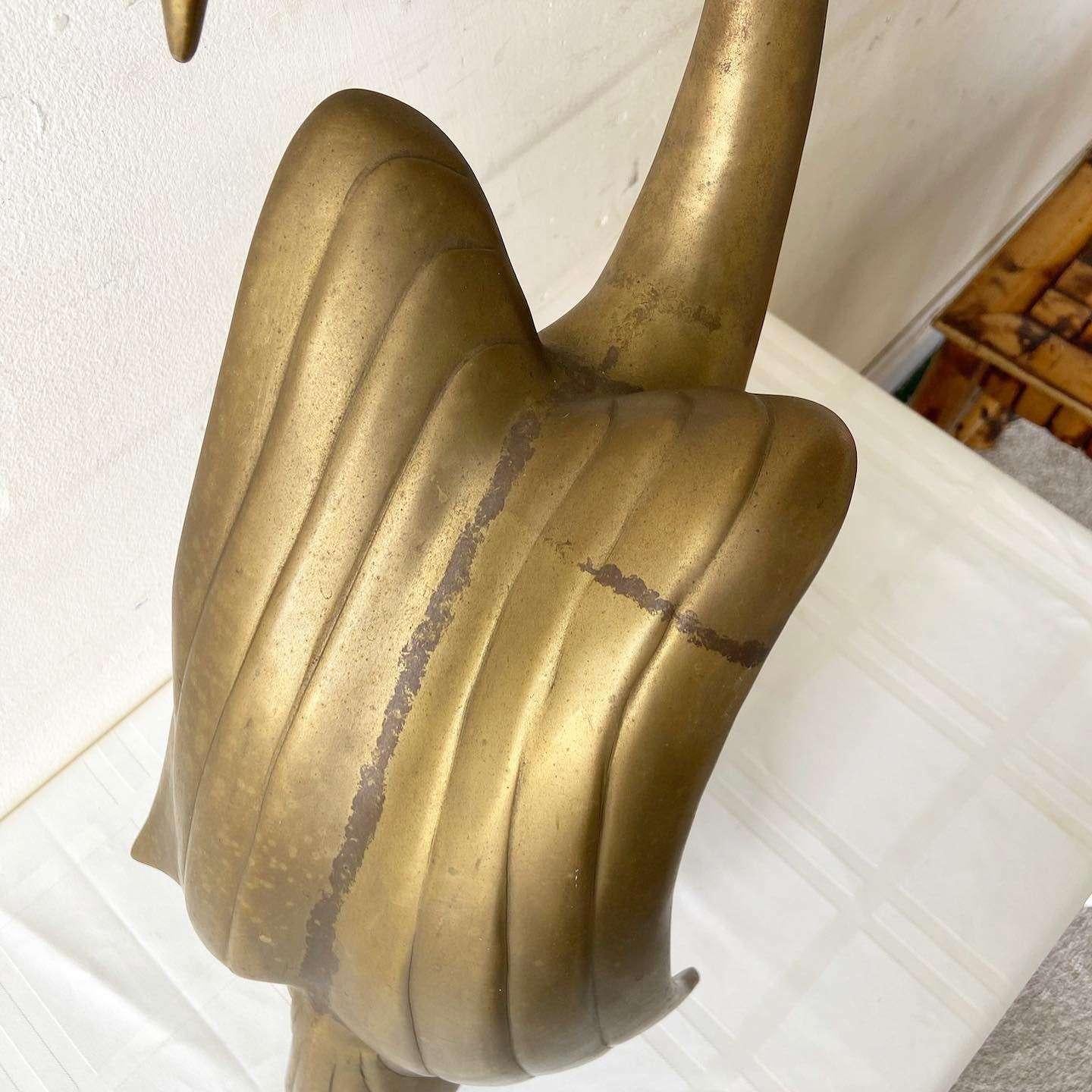 Exceptional mid century modern brass swan sculptor by Dara International, dated 1983. Displays a swan parting its wings.
