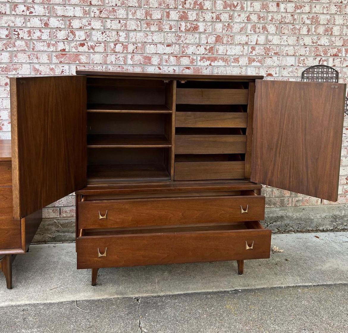 This is an amazing Broyhill Brasilia high boy. It includes 6 drawers. This collection features large, swooping wood accents and brass drawer pulls. This is a very well built set and it has been recently tuned up too! The drawers are dove-tailed. The