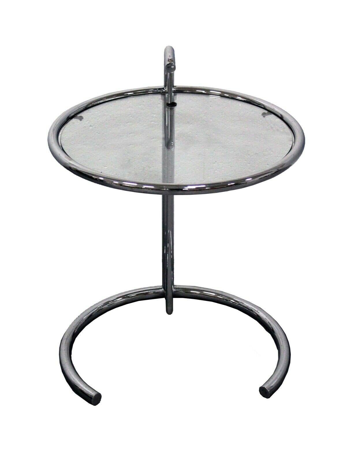 For your consideration is this iconic Eileen gray adjustable chrome side table with a glass top. Dimensions: 20 diam x 25/32h.
 