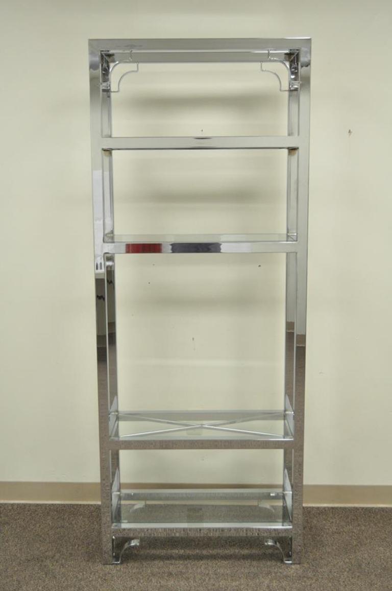 Vintage Mid-Century Modern chrome and glass display étagère. Item features beautiful chrome construction, X-form glass supports, clean modern lines, and five inset glass shelves, circa 1970. Measurements: 76