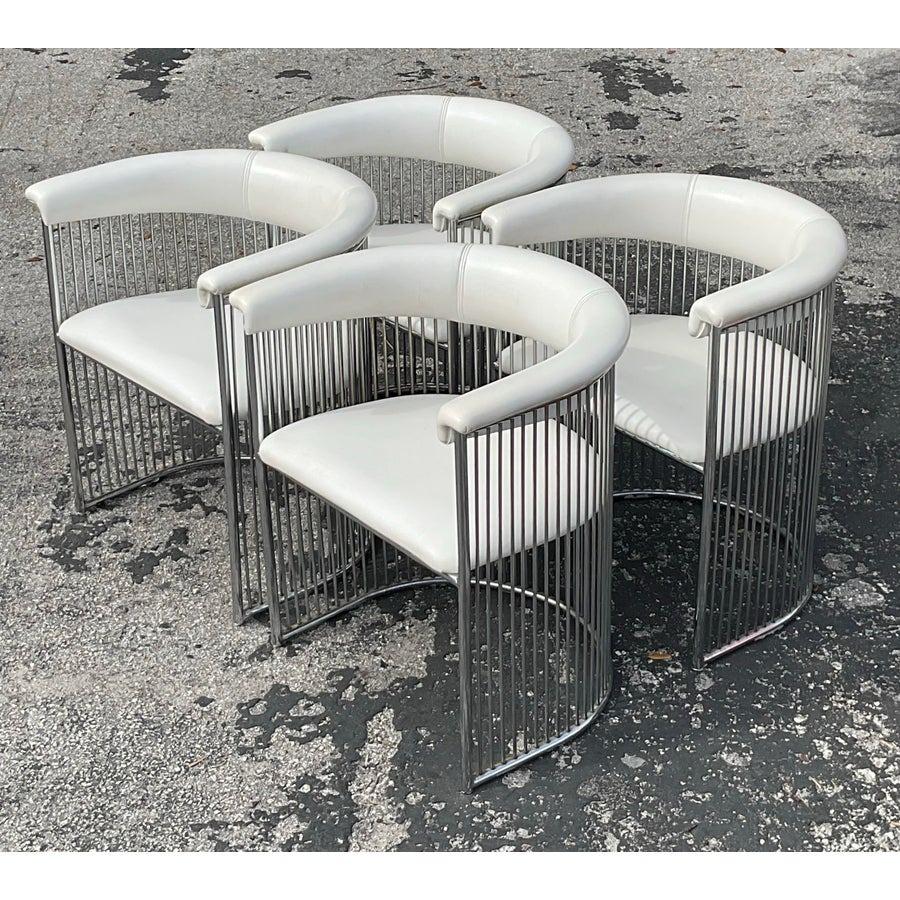 Enhance your dining area with the sleek sophistication of these vintage MCM chrome tub dining chairs, inspired by the iconic designs of Plattner. Featuring a distinctive tubular chrome frame and ergonomic design, these chairs combine mid-century