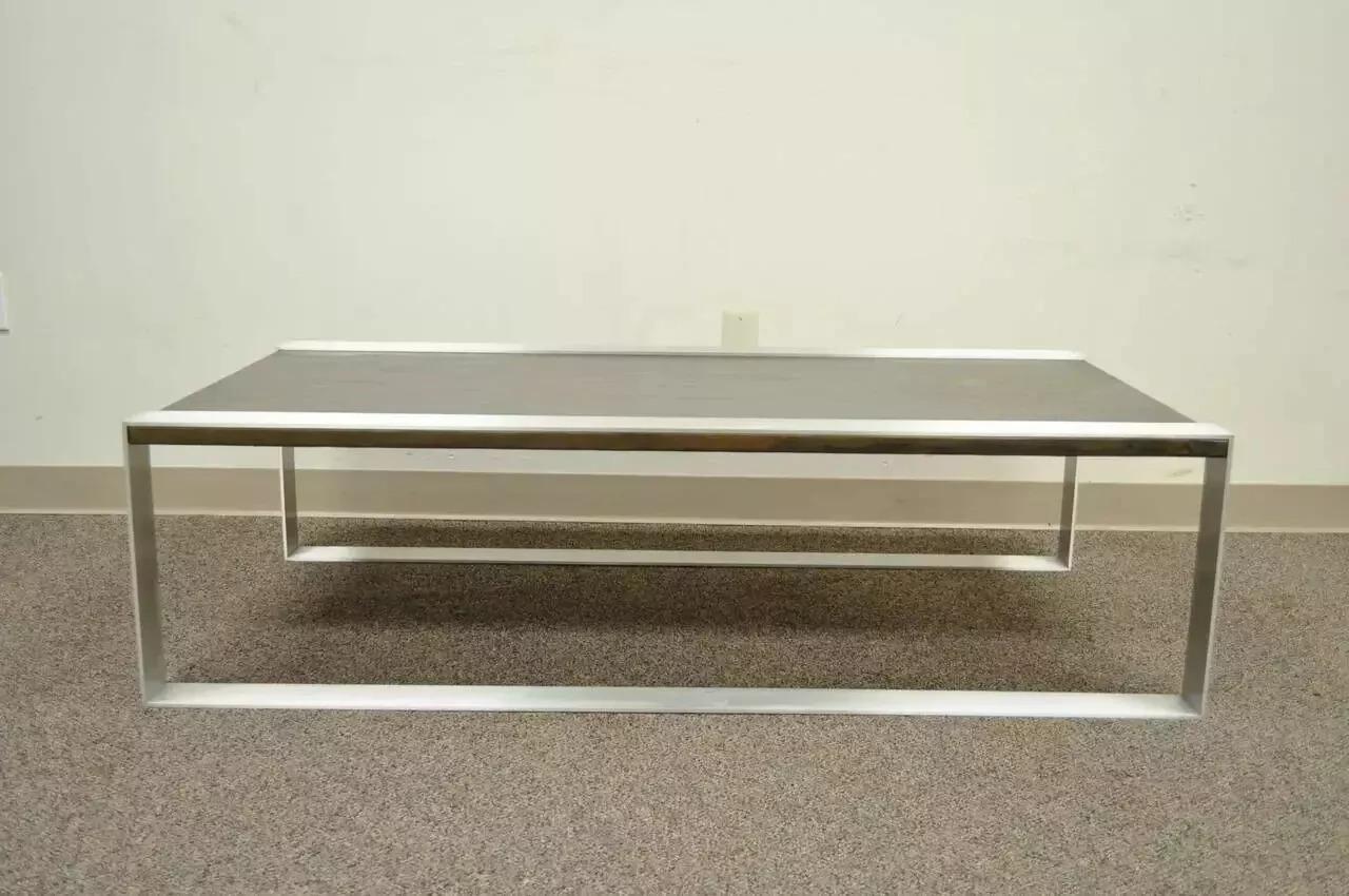 Mid Century Modern Embossed Copper and Brushed Steel Coffee Table after Laverne. Item features a flat bar brushed steel frame and an embossed copper wrapped top. The design is very similar to the works of Philip & Kelvin Laverne, as well as