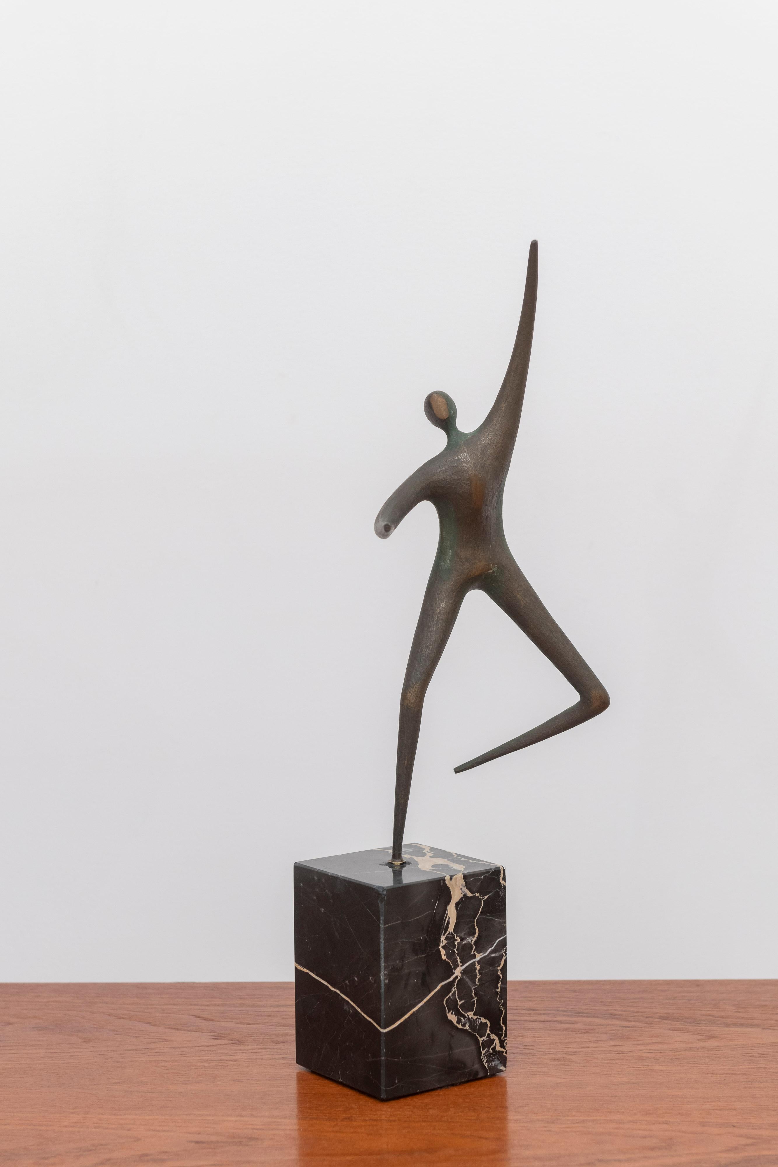 A Curtis Jere dancer brass table sculpture. This is a very dynamic sculpture from artist Curtis Jere. It showcases a dancer that can be spun to face different directions. This piece is made from a very heavy brass and is supported by a solid marble