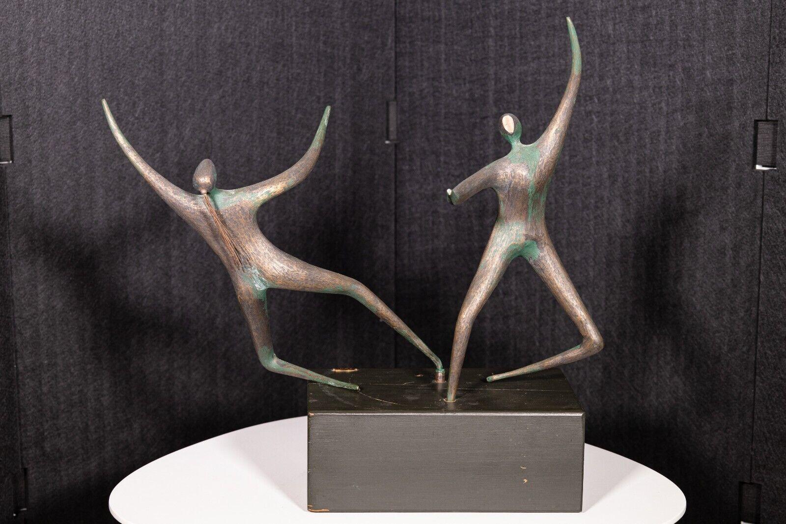 A Curtis Jere dancers brass table sculpture. This is a very dynamic sculpture from artist Curtis Jere. It showcases two dancers twirling around, each facing a different direction. This piece is made from a very heavy brass and is supported by a