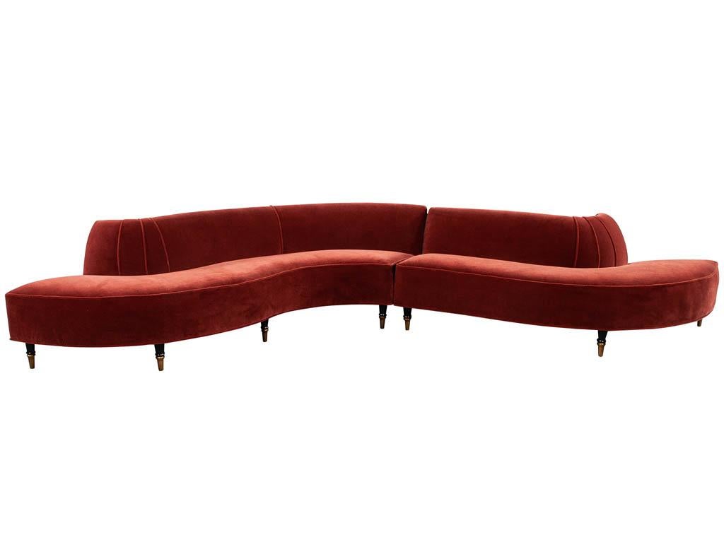 Vintage Mid-Century Modern curved sofa in rustic red mohair. Original 1960’s design completely restored and reupholstered in a rustic red mohair with ebonized wood feet and antiqued brass caps. Featuring unique fabric piping details on curved