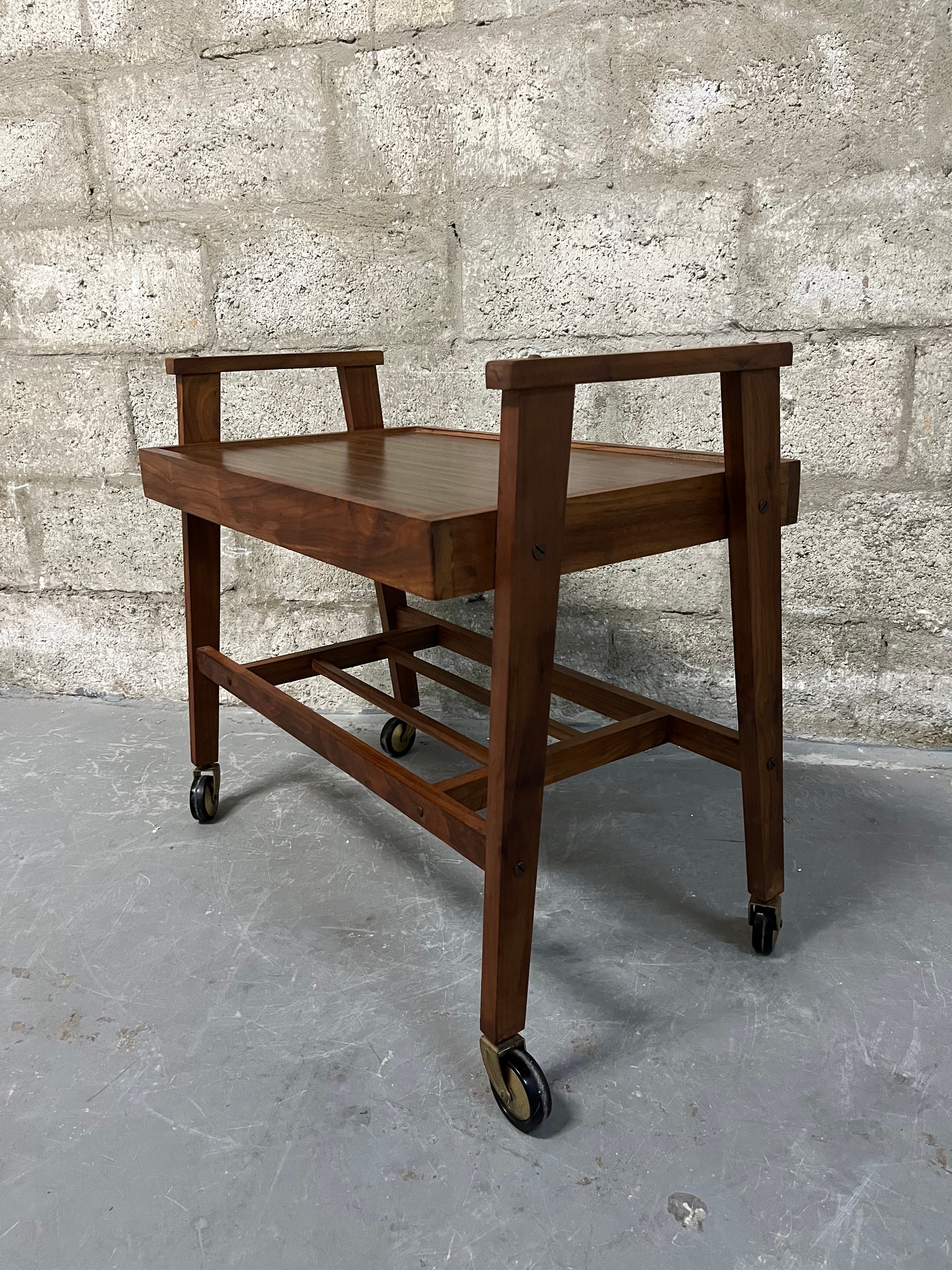 Vintage Mid Century Modern Danish Style Rolling Media Cart / TV Stand. C 1960s
This Beautiful Versatile Rolling Cart Features a sleek Mid Century Modern Design, a solid teak frame with handlers and brass casters, and a laminated top. 
In excellent