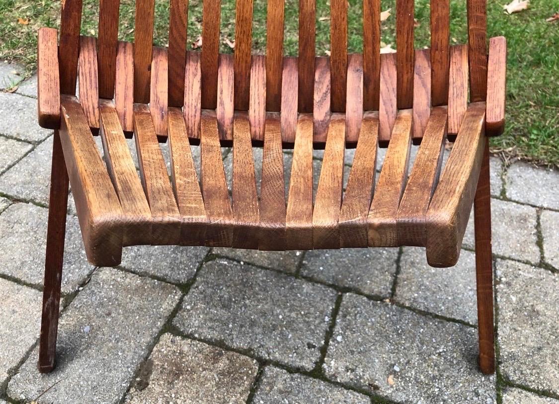 A beauty from all angles is this Danish modern teak slat chair that also folds. It has three legs, folds
up smoothly and is structurally sound with normal age appropriate wear only.