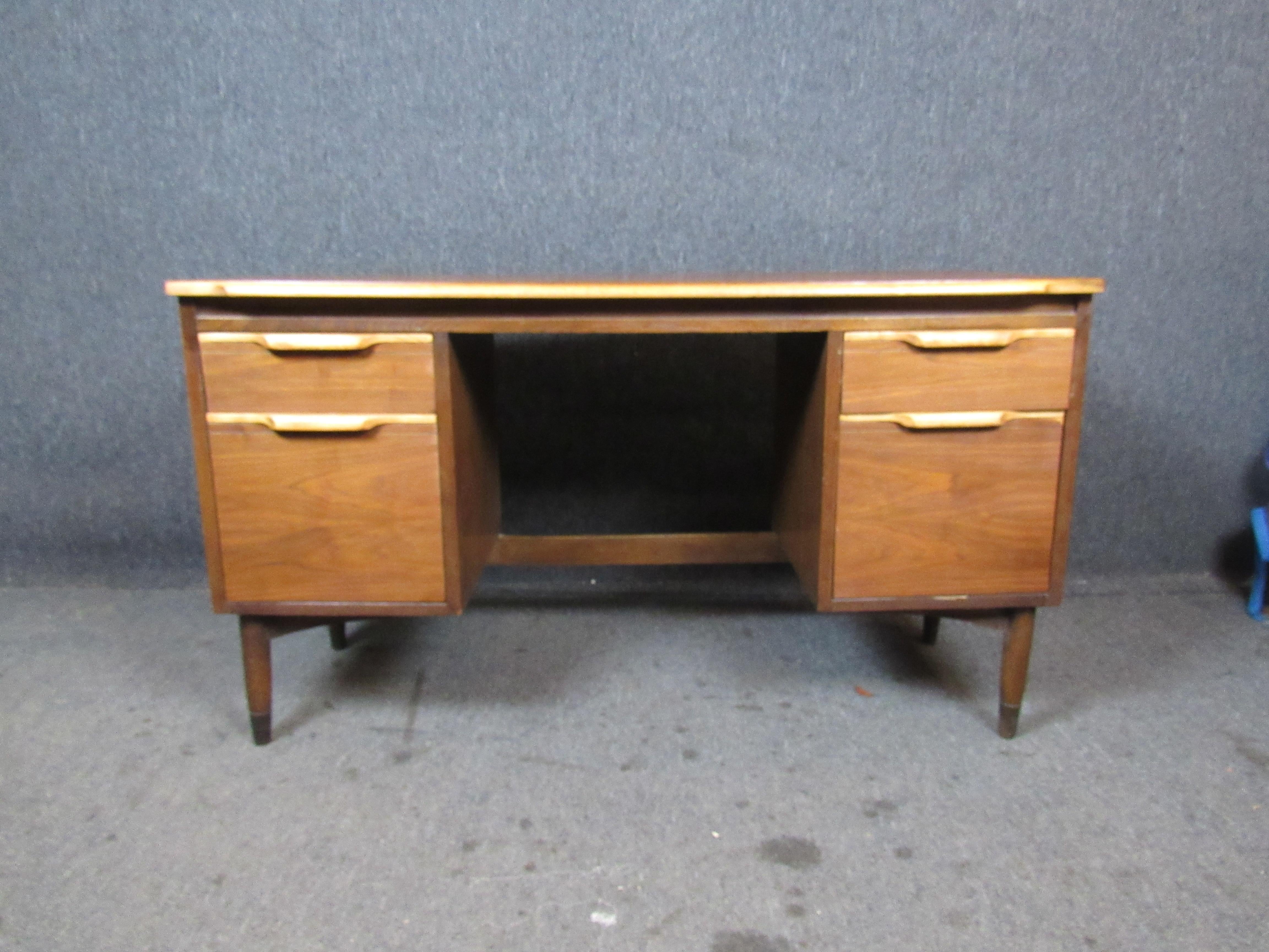 Newly refinished vintage American desk with unique features that are sure to impress! Featuring contrasting sculpted drop-pulls, a finished back, four ample drawers, and an unusual 